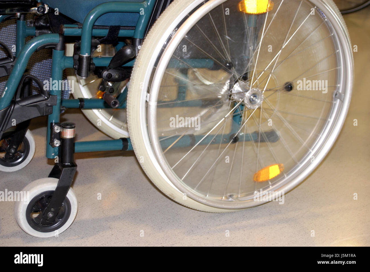 wheelchair wheel wheels mobility reflector rehab cloaks spokes valve tyre tire Stock Photo
