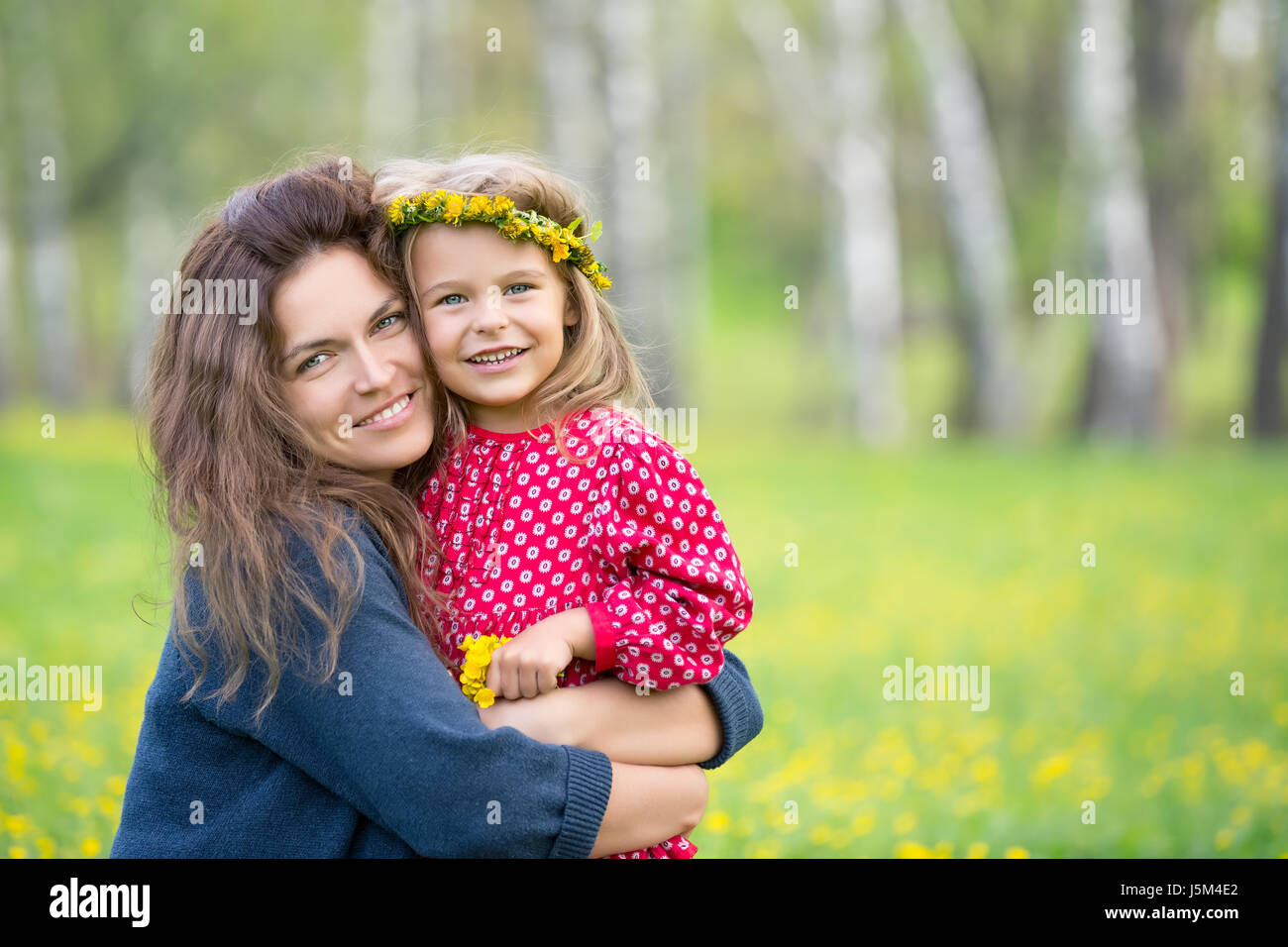 Portrait of happy mother and little daughter in spring park Stock Photo