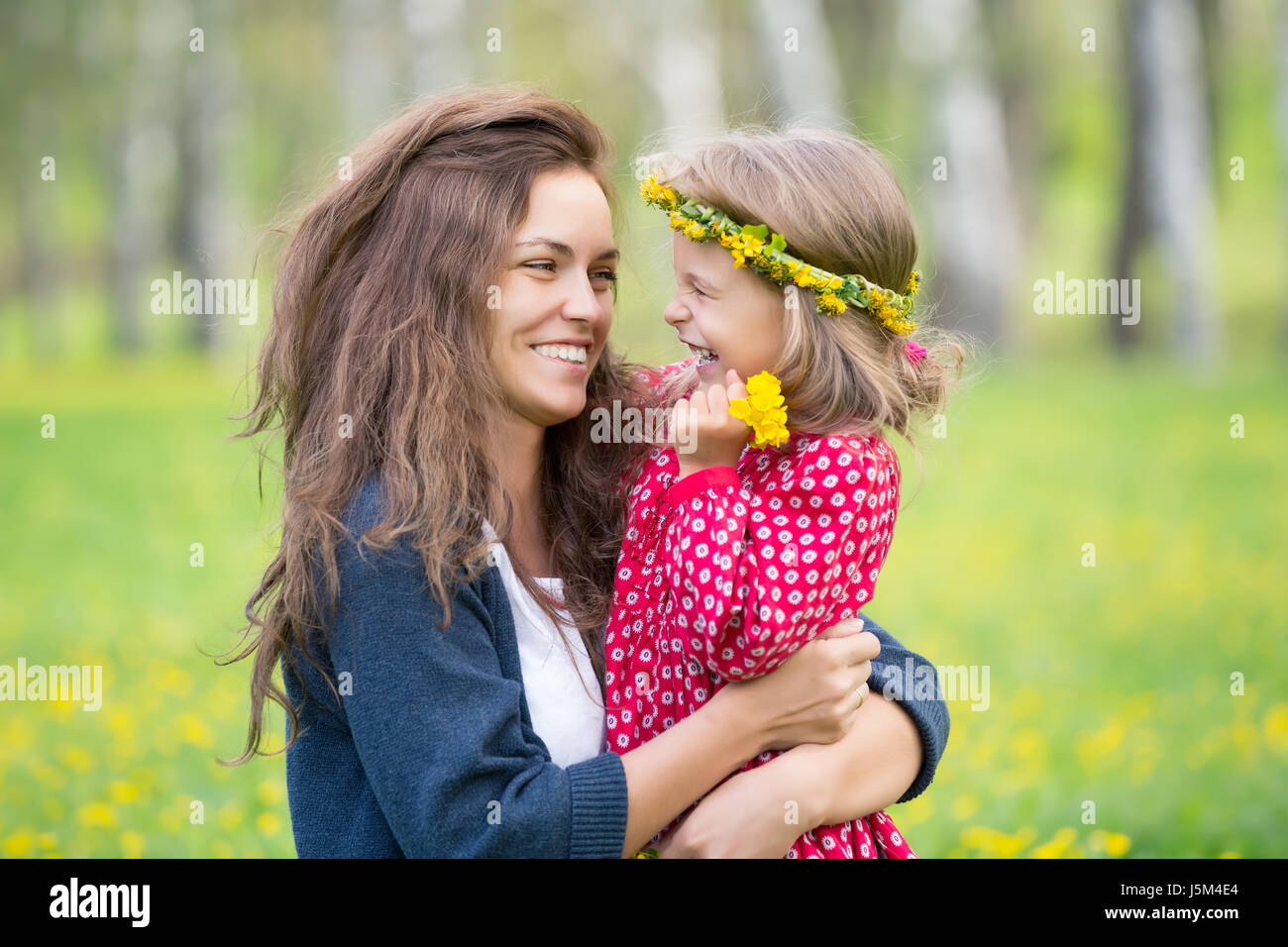 Portrait of happy mother and little daughter in spring park Stock Photo