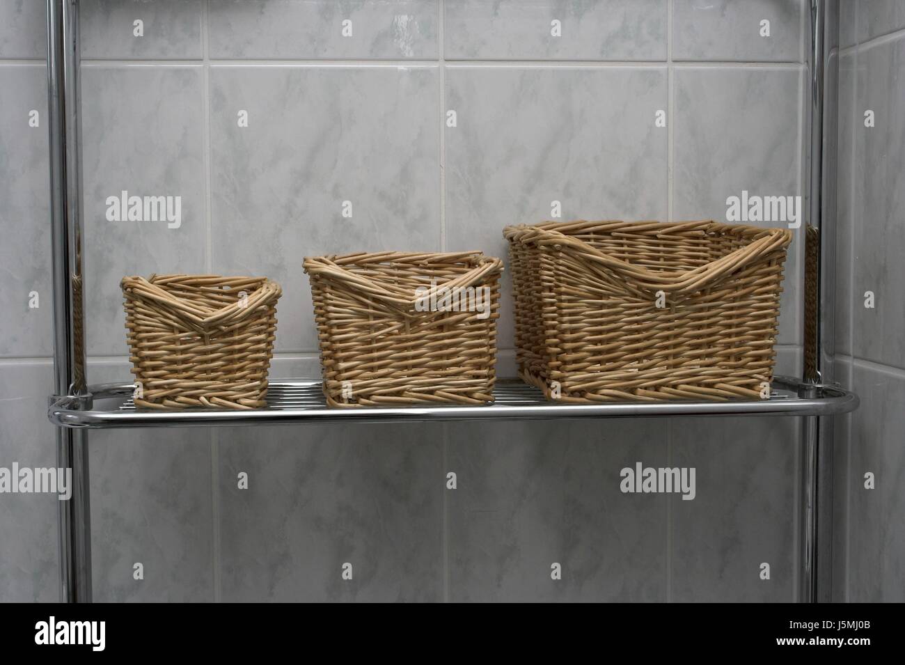basket small tiny little short shelf tile chromes bathroom average wall 654 Stock Photo