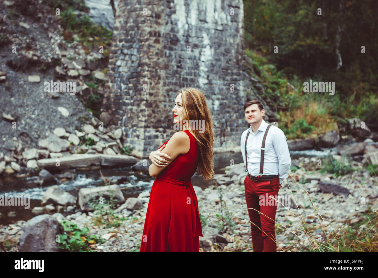 Couple standing in the nature, the girl in front Stock Photo - Alamy