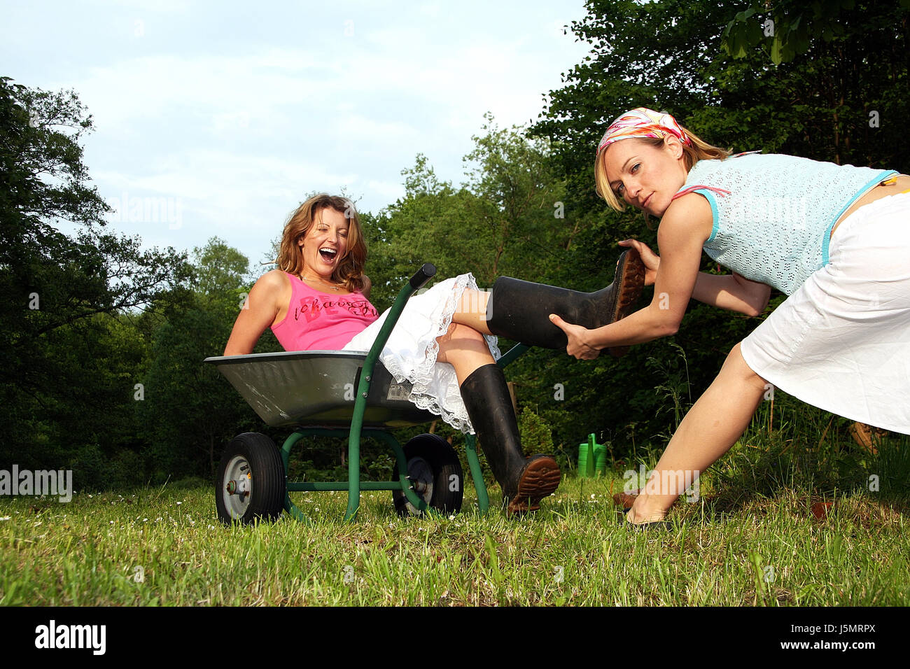 wheelbarrow in the garden Stock Photo - Alamy