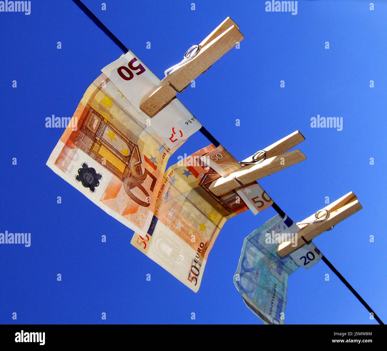 pay euro save wash washing bank note bank notes tickets clothesline laundry Stock Photo