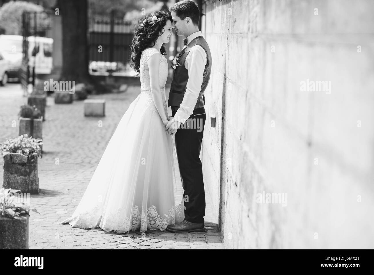 bride and groom walking in old city Stock Photo - Alamy