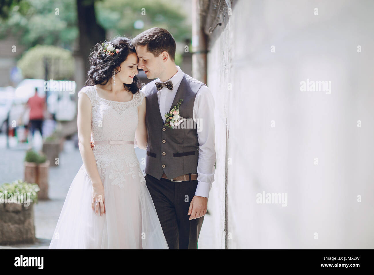 bride and groom walking in old city Stock Photo - Alamy