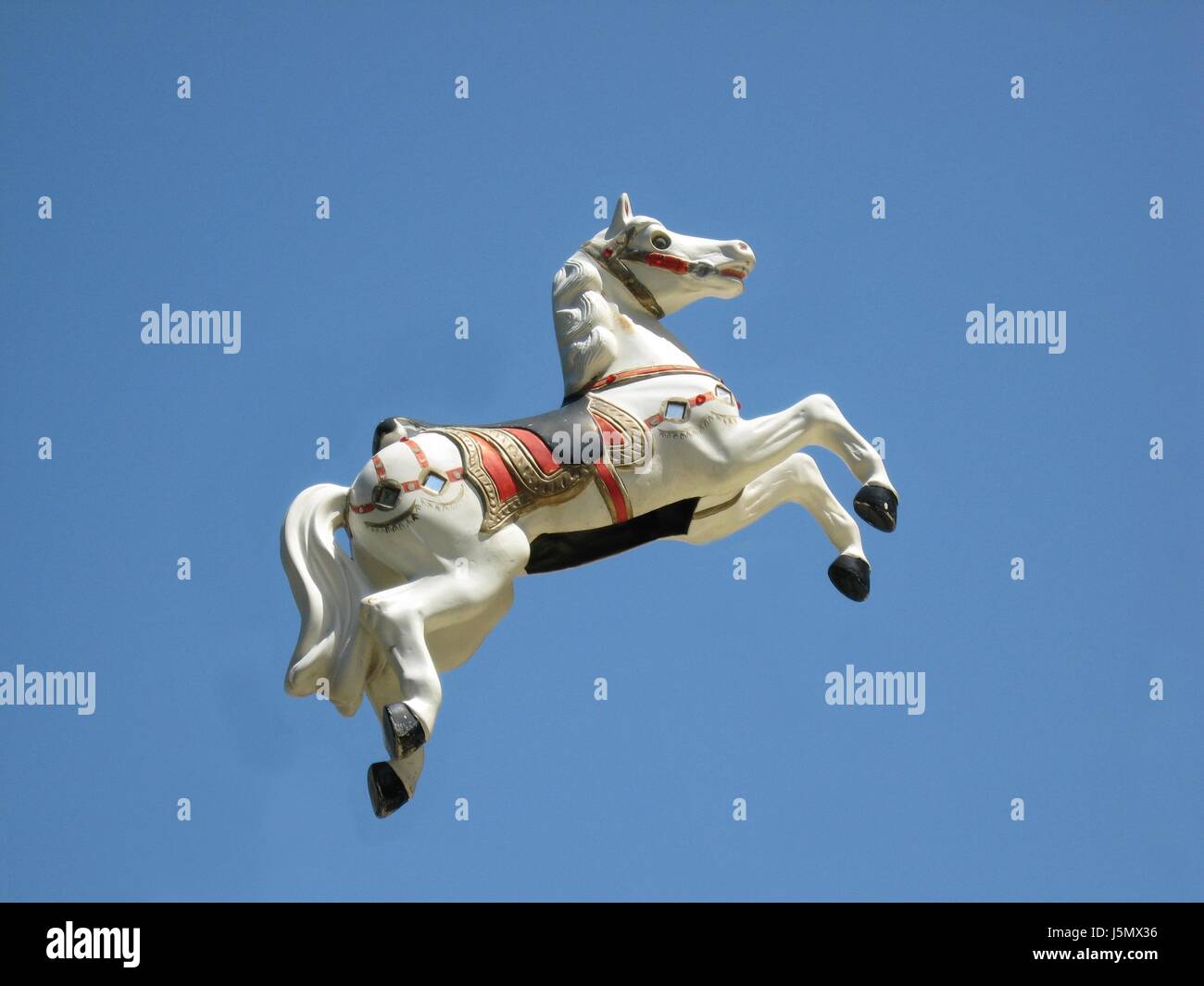 blue horse fair firmament sky ride float merry-go-round levitation horseriding Stock Photo