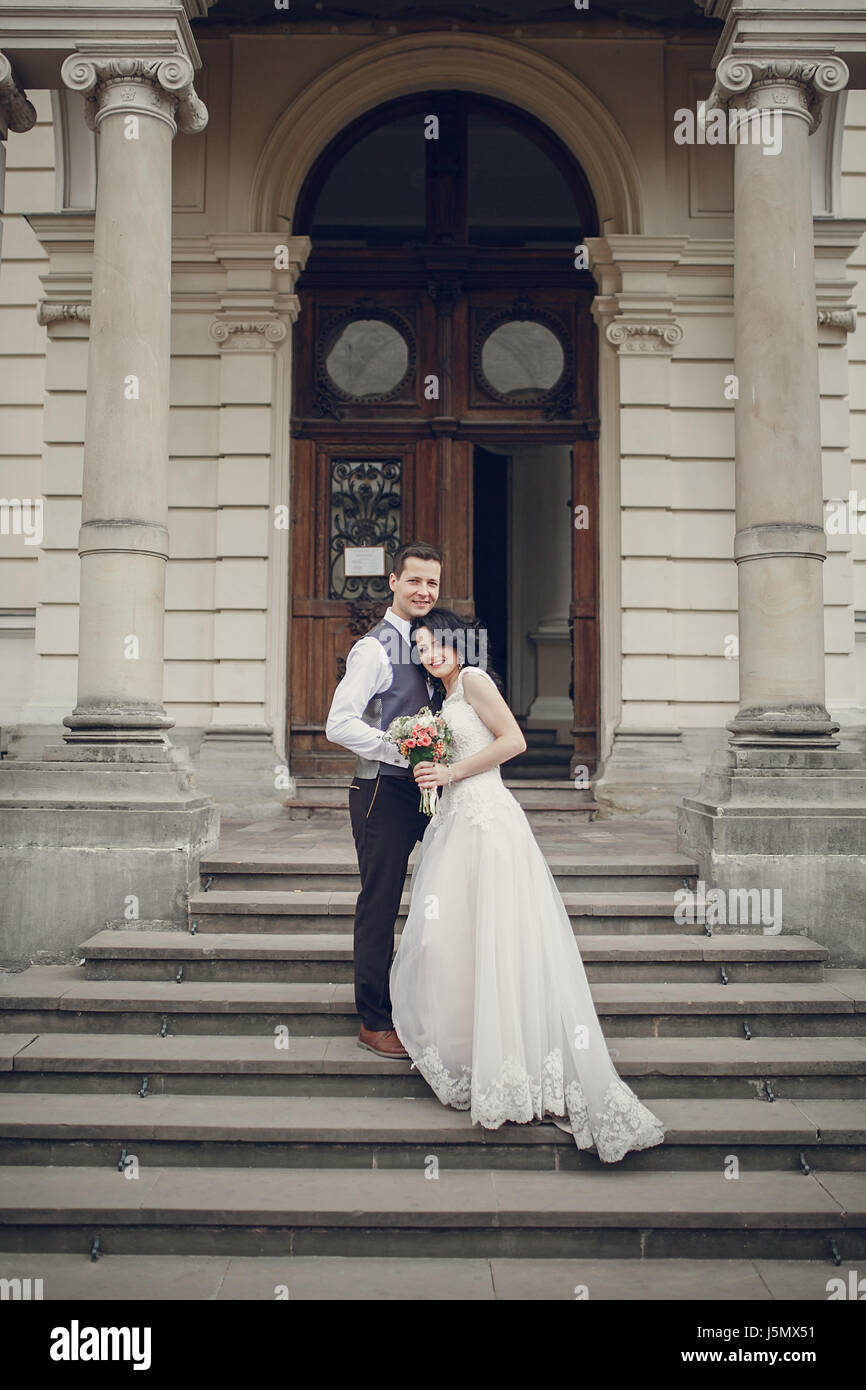 bride and groom walking in old city Stock Photo - Alamy