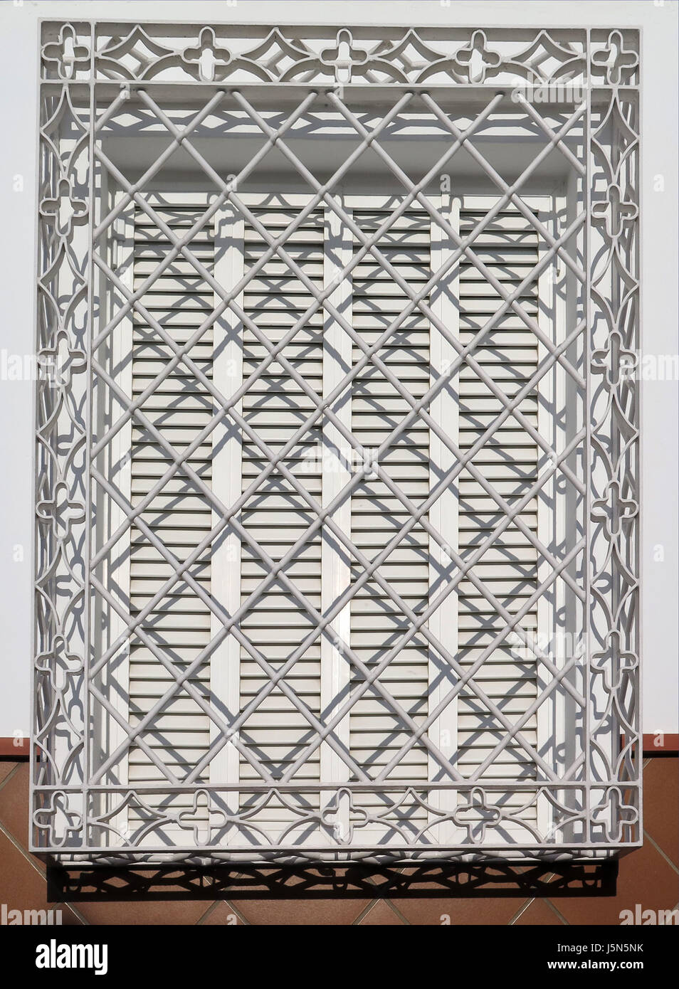White Decorative iron grill over residential window Stock Photo