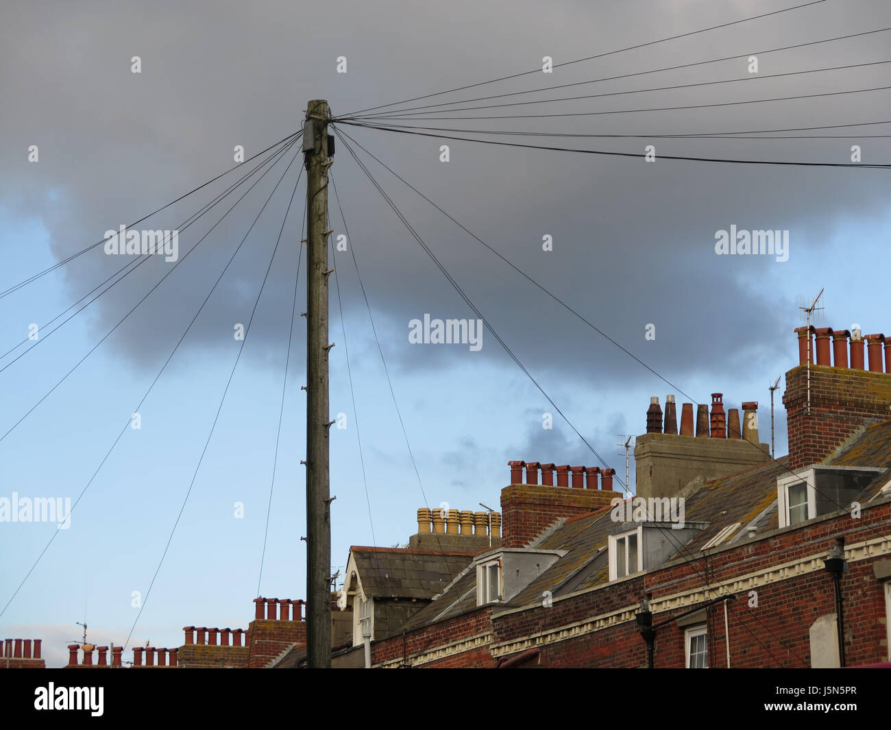 Telegraph Pole and Chimney Stacks against cloudy sky in Weymouth, Dorset, UK Stock Photo