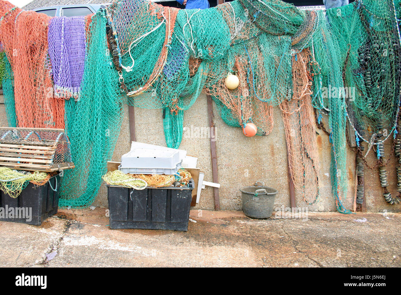 Colored or coloured fishing nets hanging in the sun to dry. Stock Photo