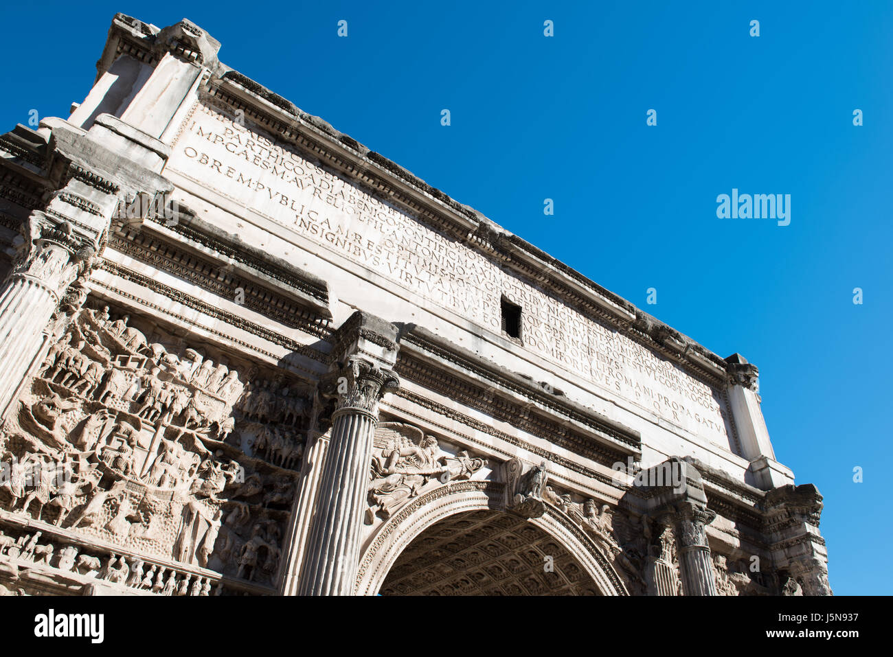 Rome Roman forum Arch of Septimius Severus against blue sky low angle view Stock Photo