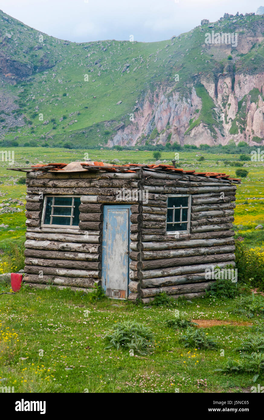 A Log Cabin Stands Alone In The High Caucasus Of Georgia Stock