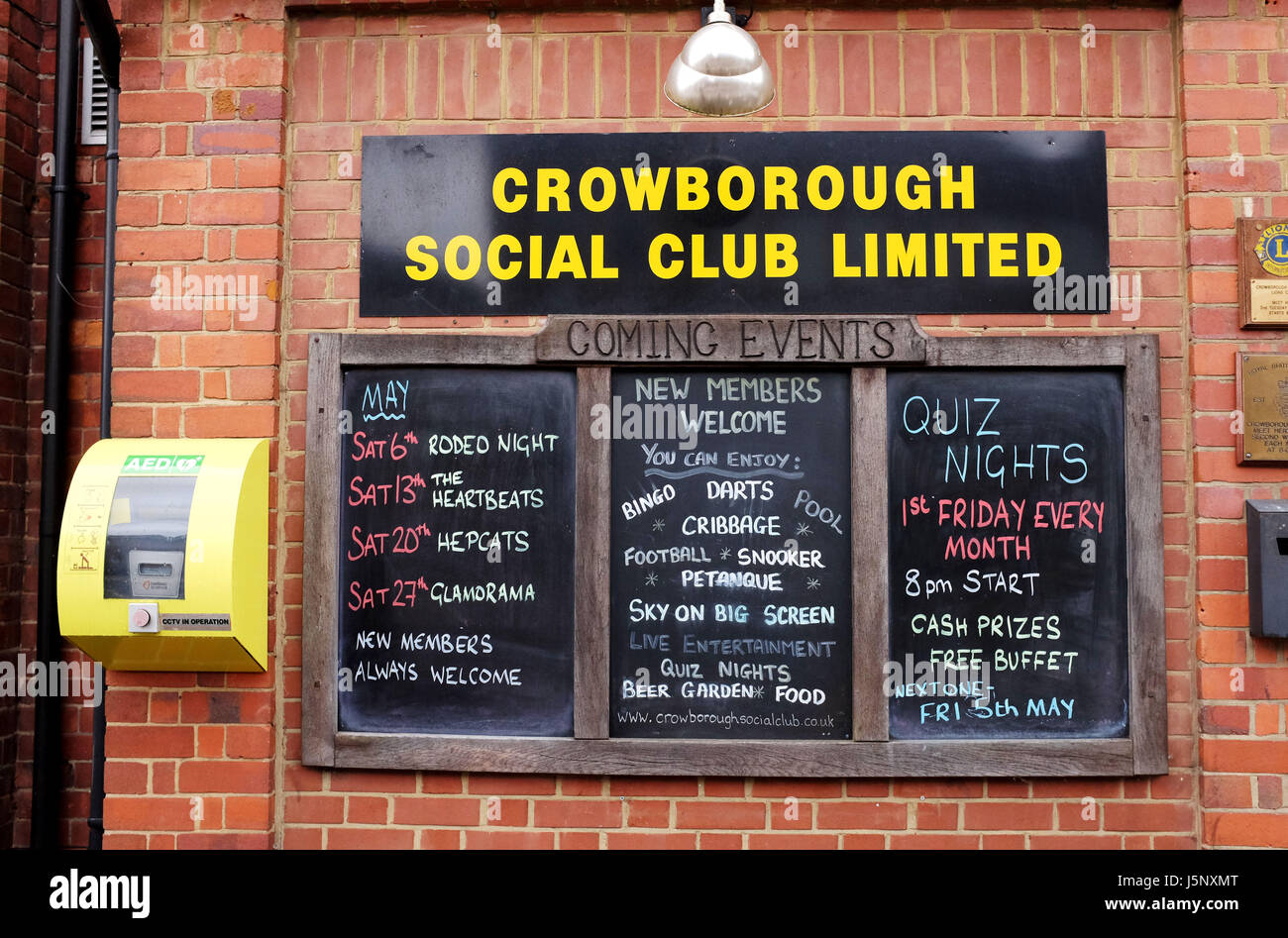Crowborough East Sussex UK - Public defibrillator on wall by Crowborough Social Club notice board Stock Photo