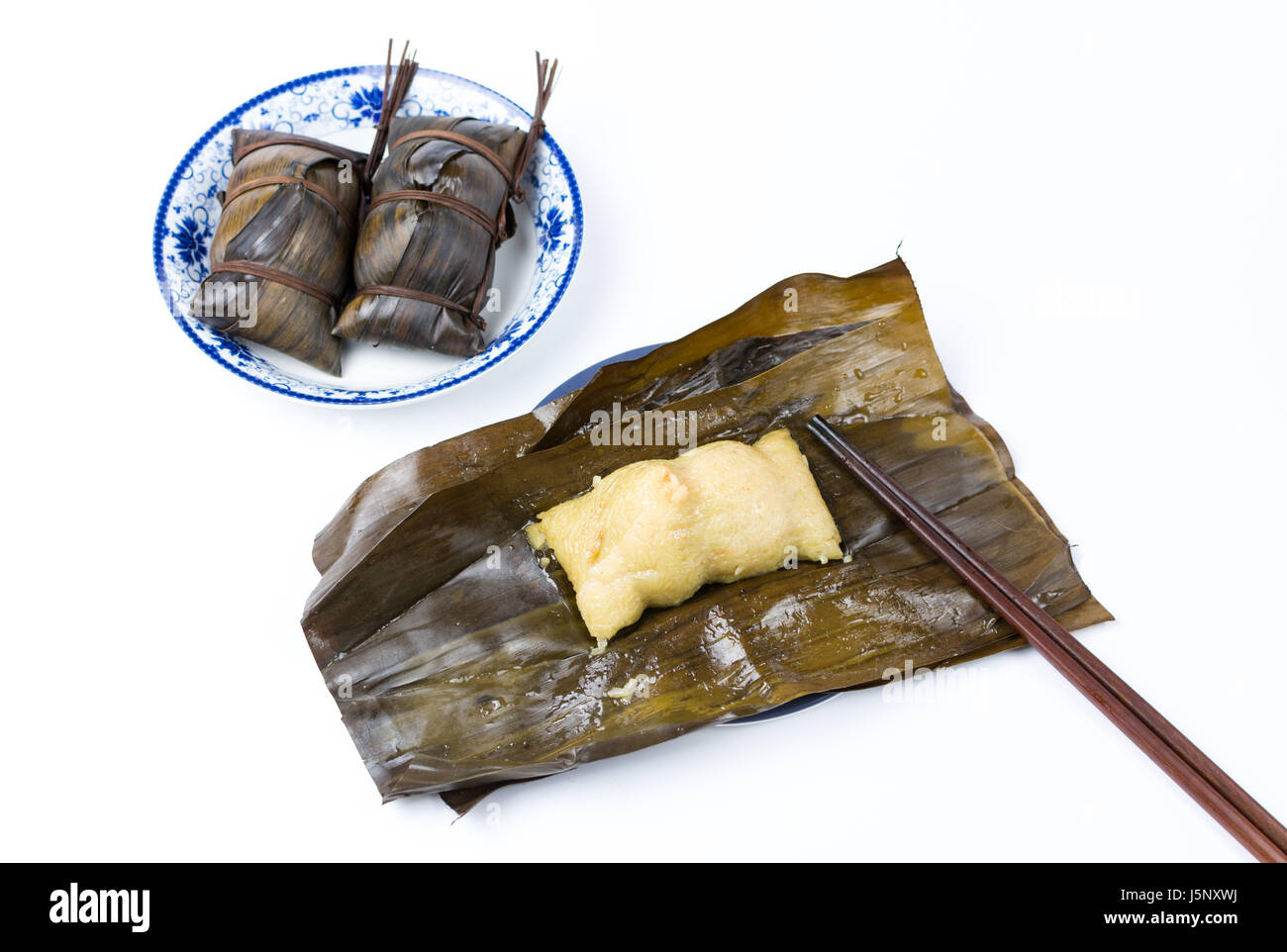 Open Zongzi with chopsticks, traditional Chinese food usually prepared for the Dragon Boat Festival Stock Photo