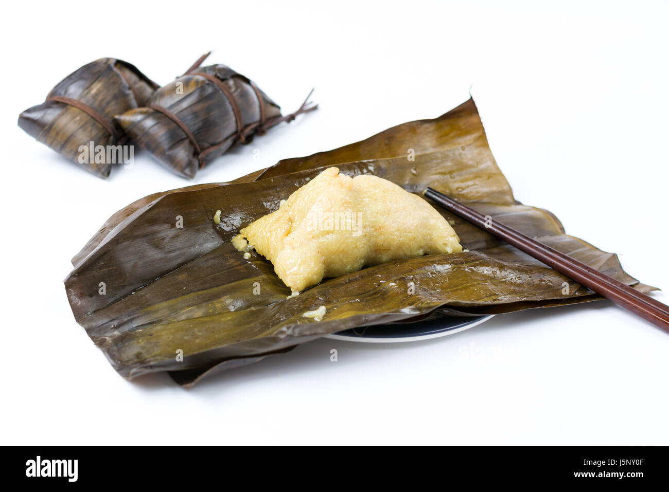 Open Zongzi with chopsticks, traditional Chinese food usually prepared for the Dragon Boat Festival Stock Photo
