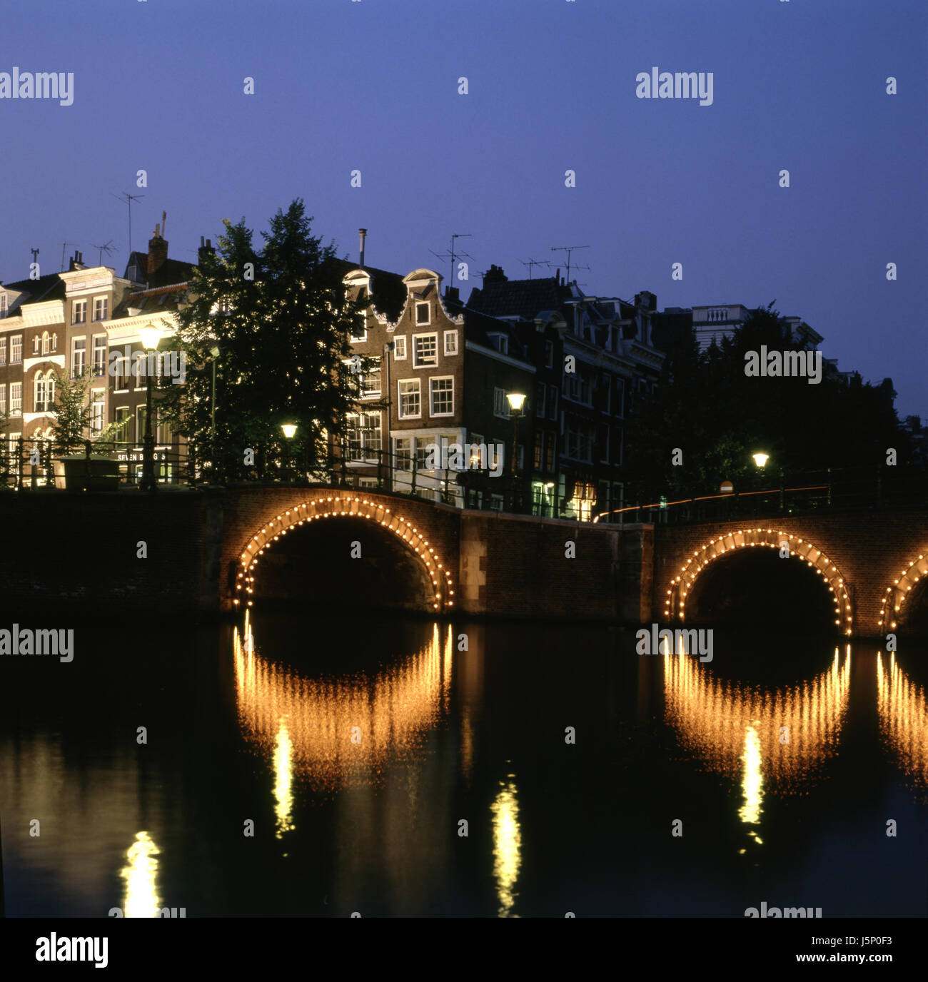 city town tree trees night nighttime channel mirroring holland netherlands Stock Photo