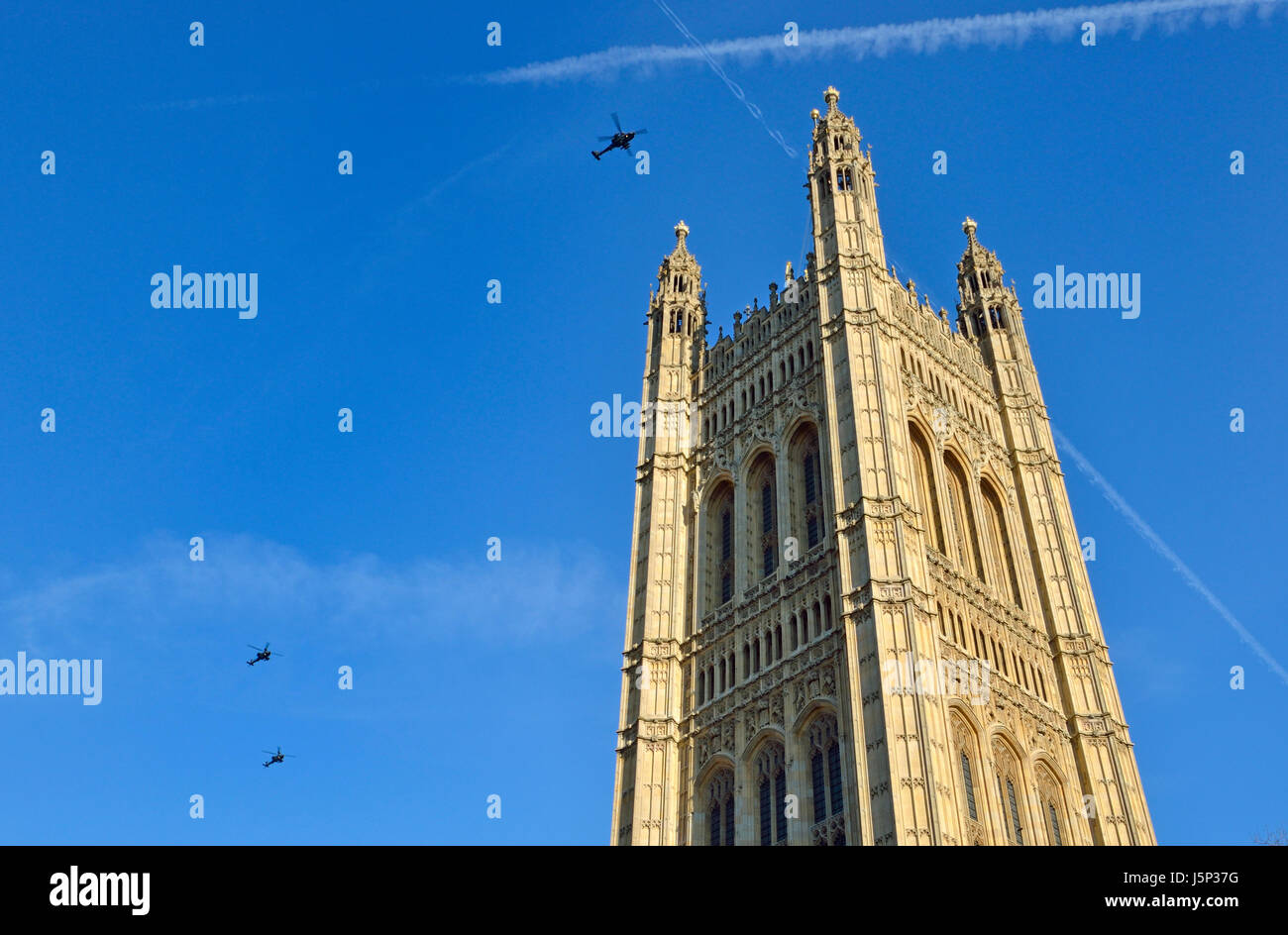 London, England, UK. Helicopters flying over the Houses of Parliament - Victoria Tower Stock Photo