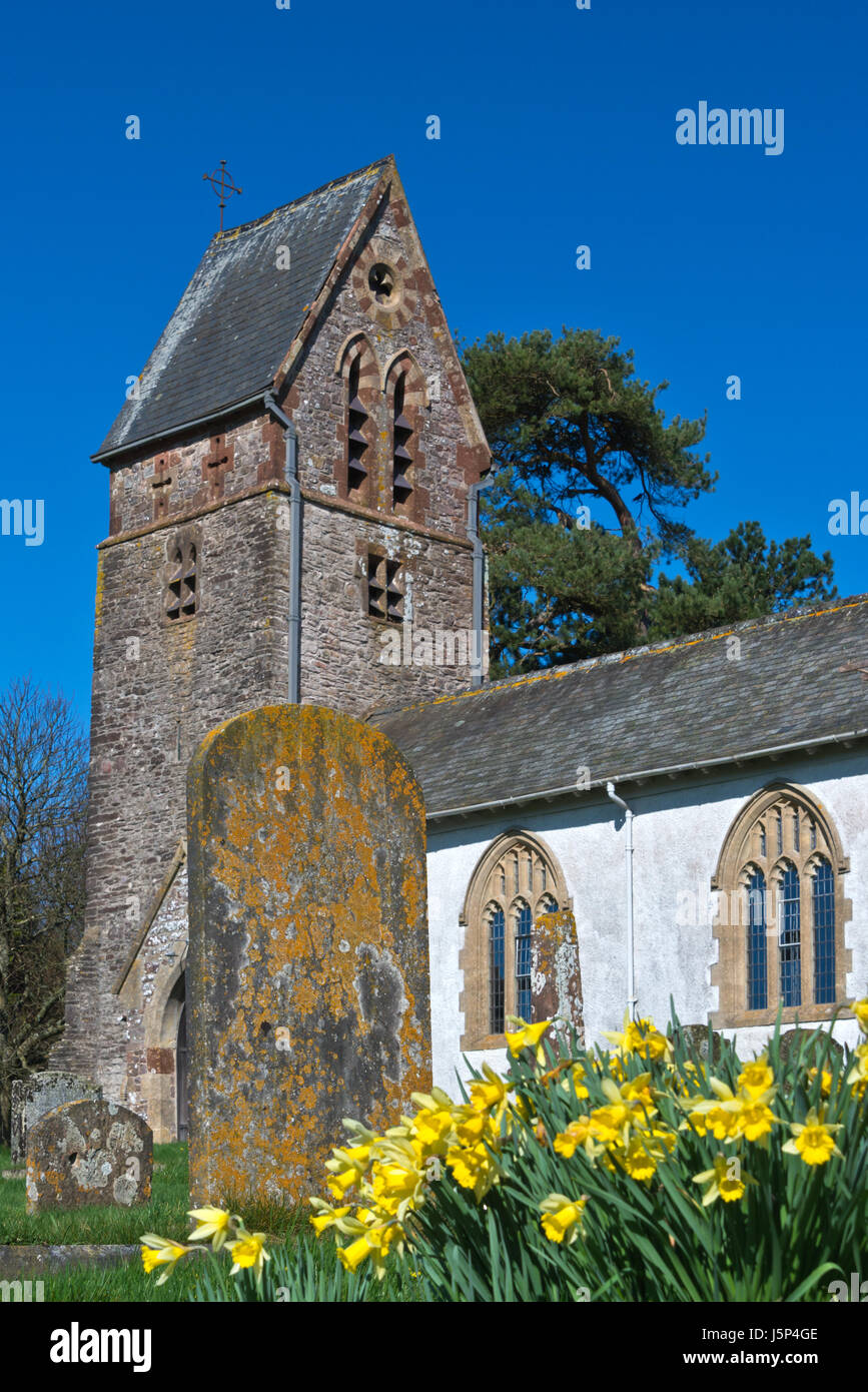 The Graveyard and saddle-back tower of St Marys church in Churchtown, Luxborough in the Brendon Hills, part of Somersets Exmoor National Park Stock Photo