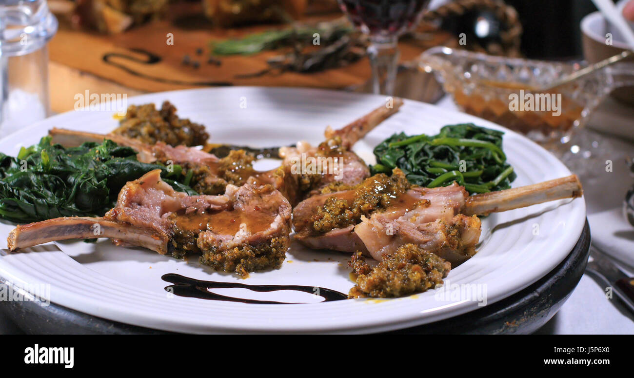 A rack of lamb in crusted mint sauce with spinach Stock Photo Alamy