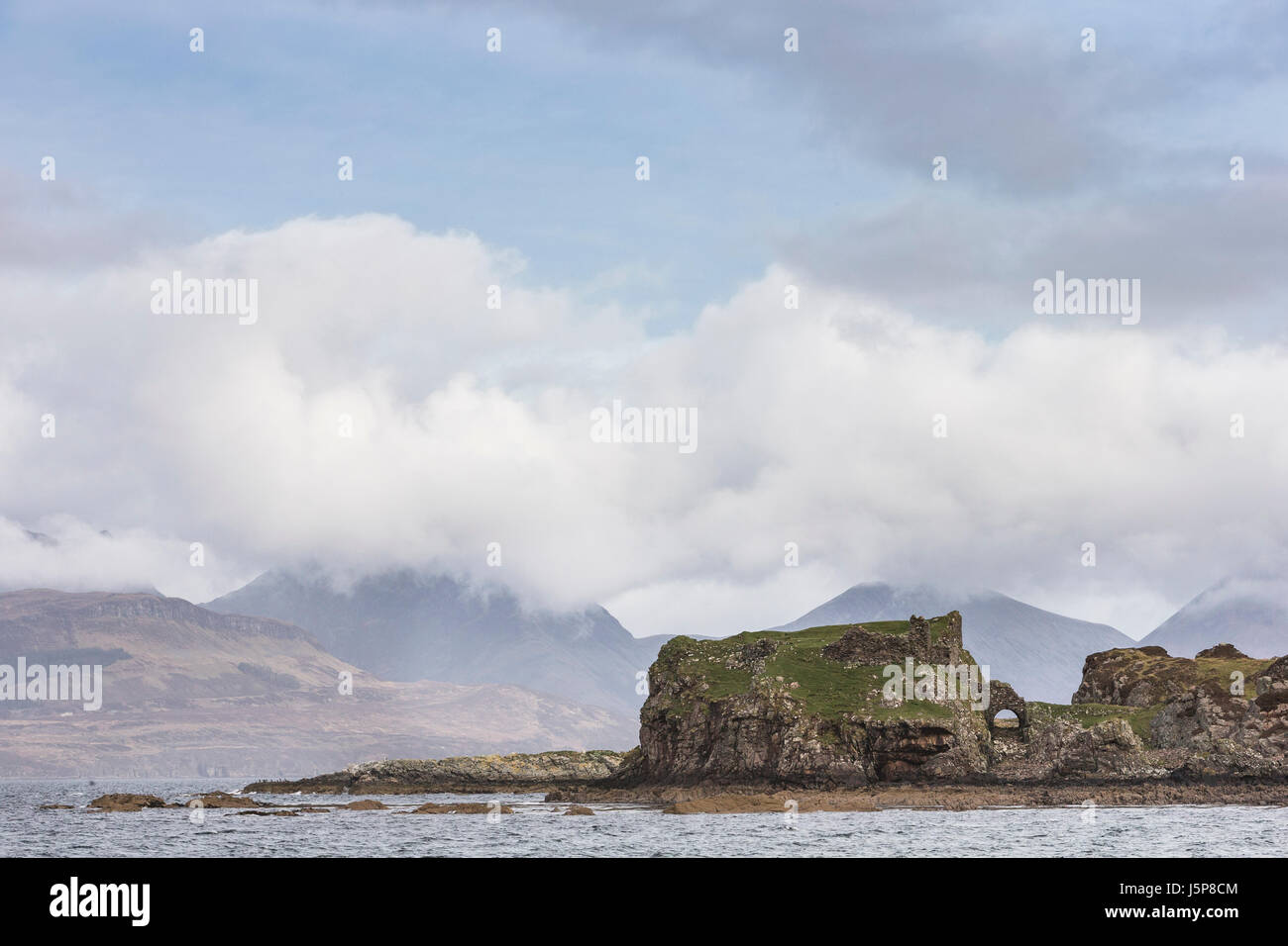 Dunscaith Castle ruins and Cuilin on Loch Eishort on the Isle of Skye in Scotland. Stock Photo