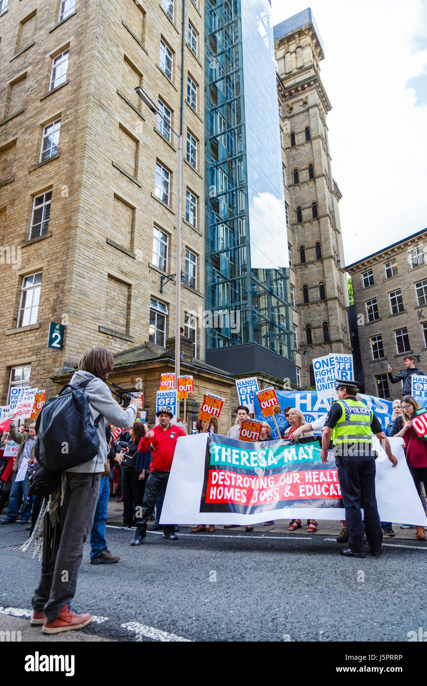 Halifax, UK. 18th May, 2017. Demonstrators arrive  at Dean Clough Mills, Halifax,  to protest the launch of the Conservative Party manifesto Halifax, England. 18th May 2017. Credit: Graham Hardy/Alamy Live News Stock Photo