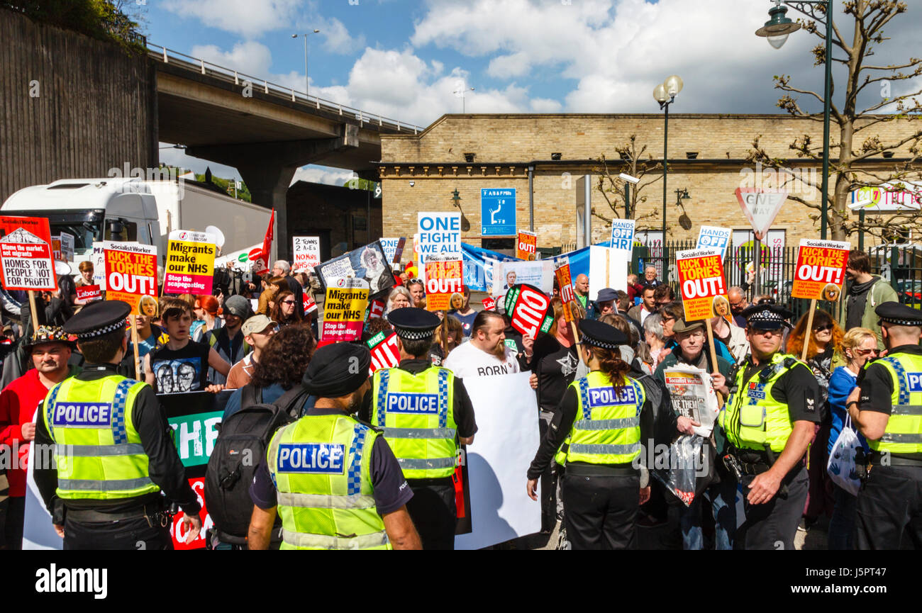Halifax, UK. 18th May, 2017. A large police presence prevents demonstrators from entering Dean Clough Mills, Halifax where the Conservative Party were launching their manifesto. Credit: Graham Hardy/Alamy Live News Stock Photo