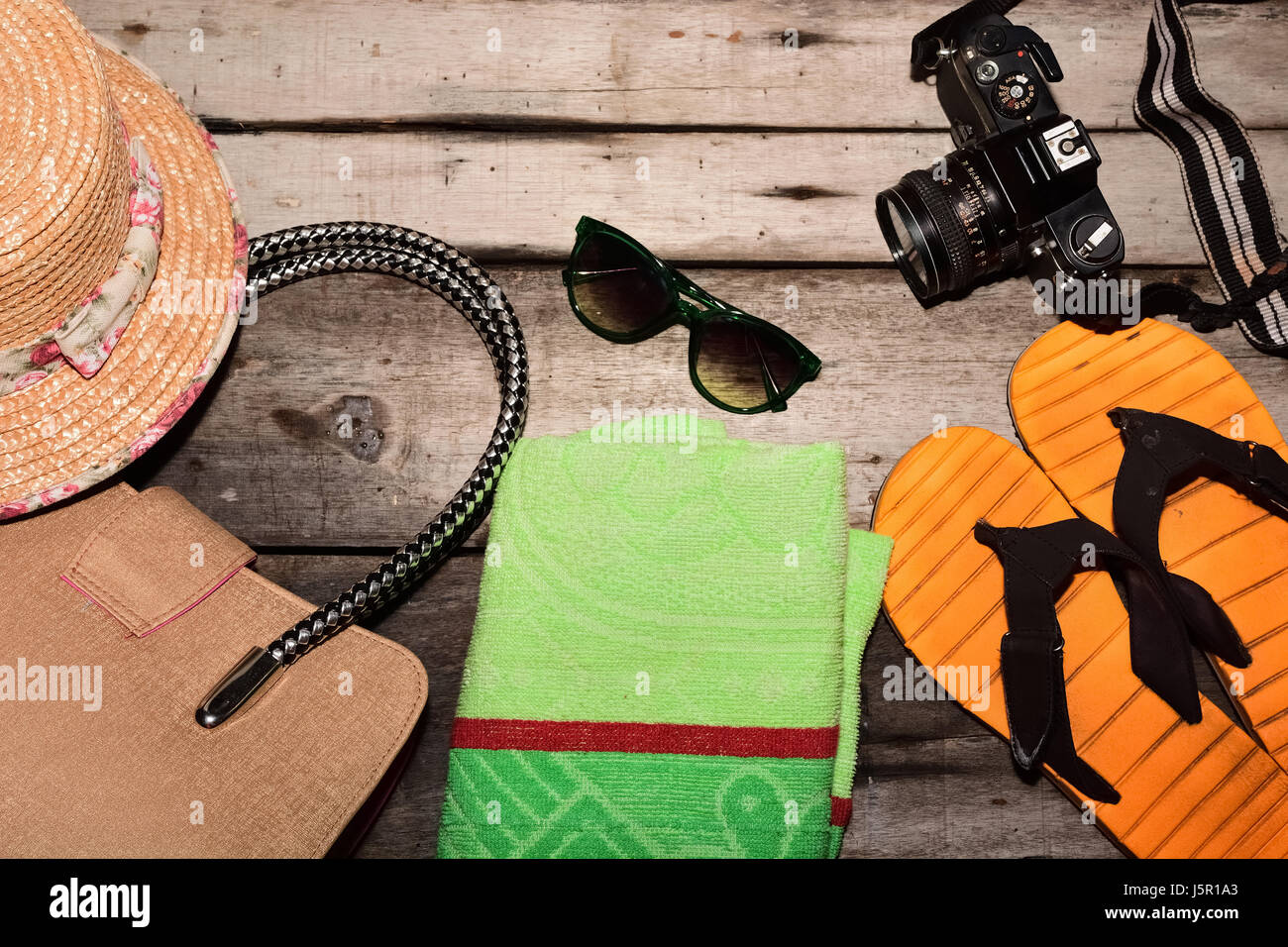 Men's beach clothes and accessories on wooden table Stock Photo - Alamy