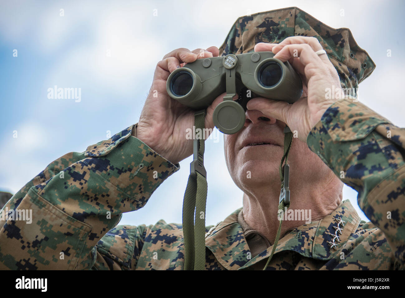 U.S. Marine Corps Commandant Robert Neller watches an amphibious demonstration through binoculars during the Pacific Amphibious Leaders Symposium April 2, 2017 in Pohang, South Korea.    (photo by Samantha K. Braun/US Marines  via Planetpix) Stock Photo
