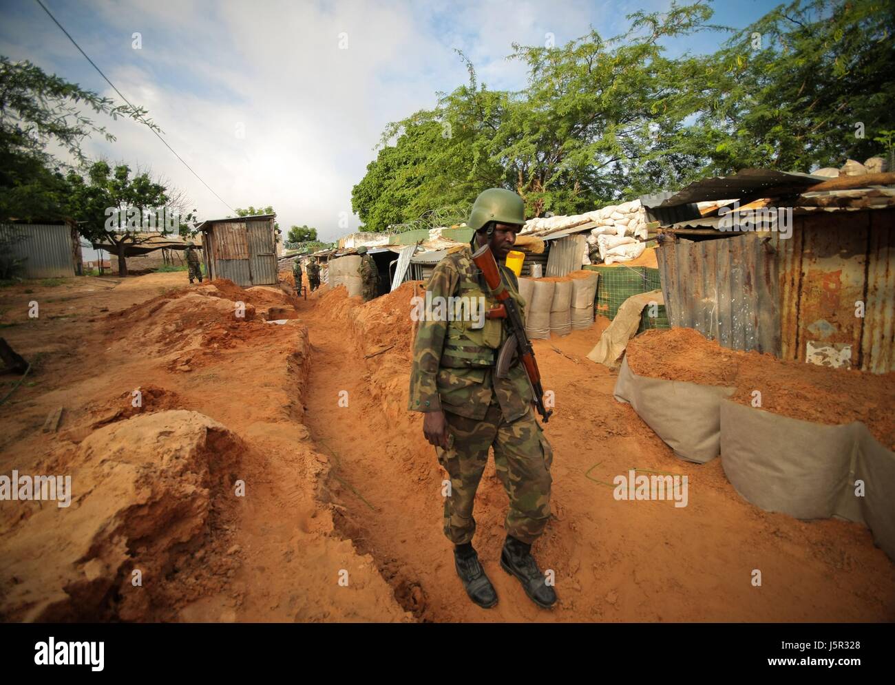 An African Union Mission in Somalia (AMISOM) Ugandan soldier walks through a trench along the frontline of the Yaaqshiid District, where AMISOM forces have pushed Al Shabaab militants November 23, 2011 near Mogadishu, Somalia.     (photo by Stuart Price/ANISOM via Planetpix) Stock Photo