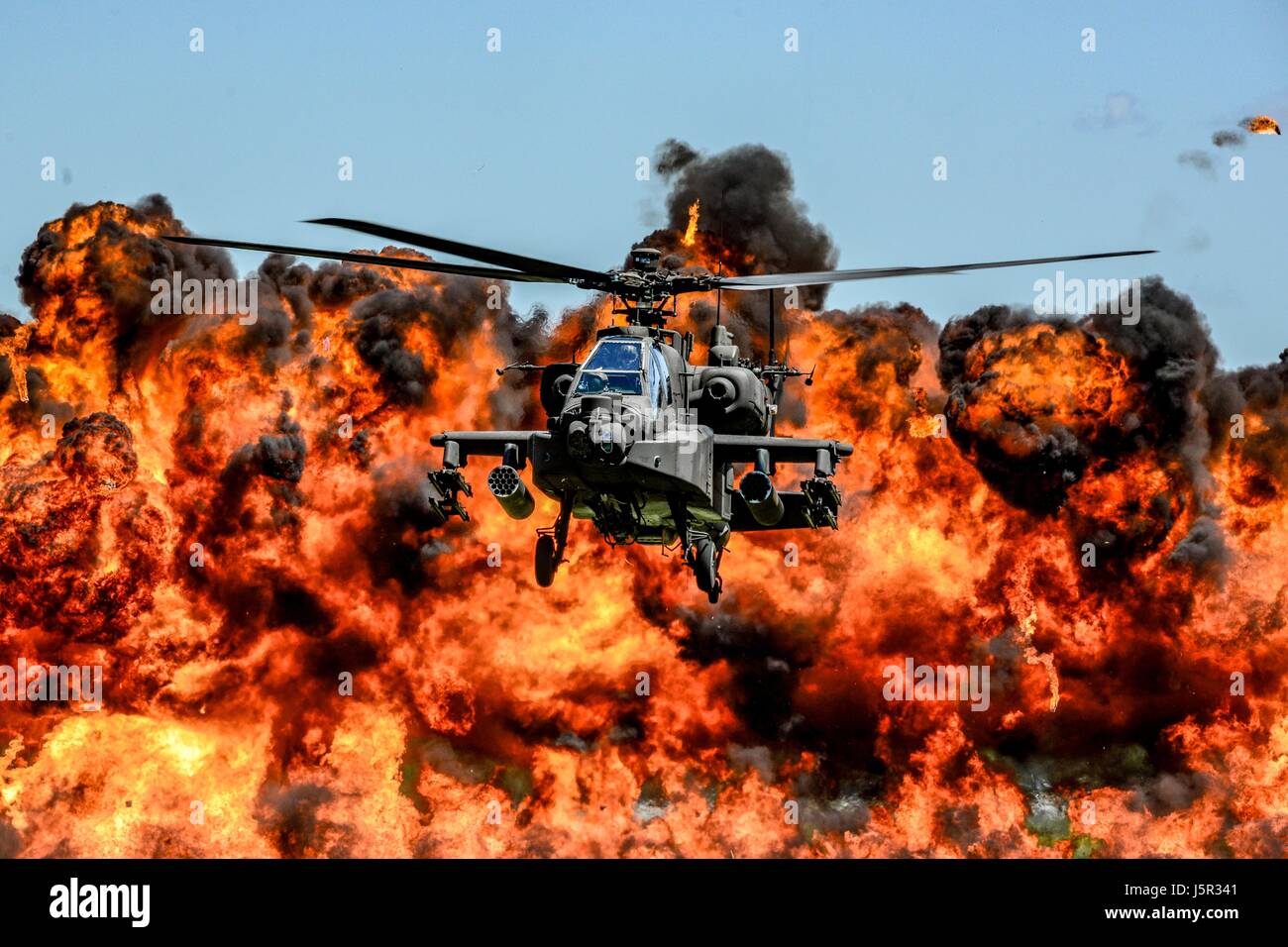 A U.S. Army AH-64D Apache attack helicopter flies in front of a wall of fire during the South Carolina National Guard Air and Ground Expo at the McEntire Joint National Guard Base May 6, 2017 in Hopkins, South Carolina. (photo by Jorge Intriago /US Airforce Photo via Planetpix) Stock Photo