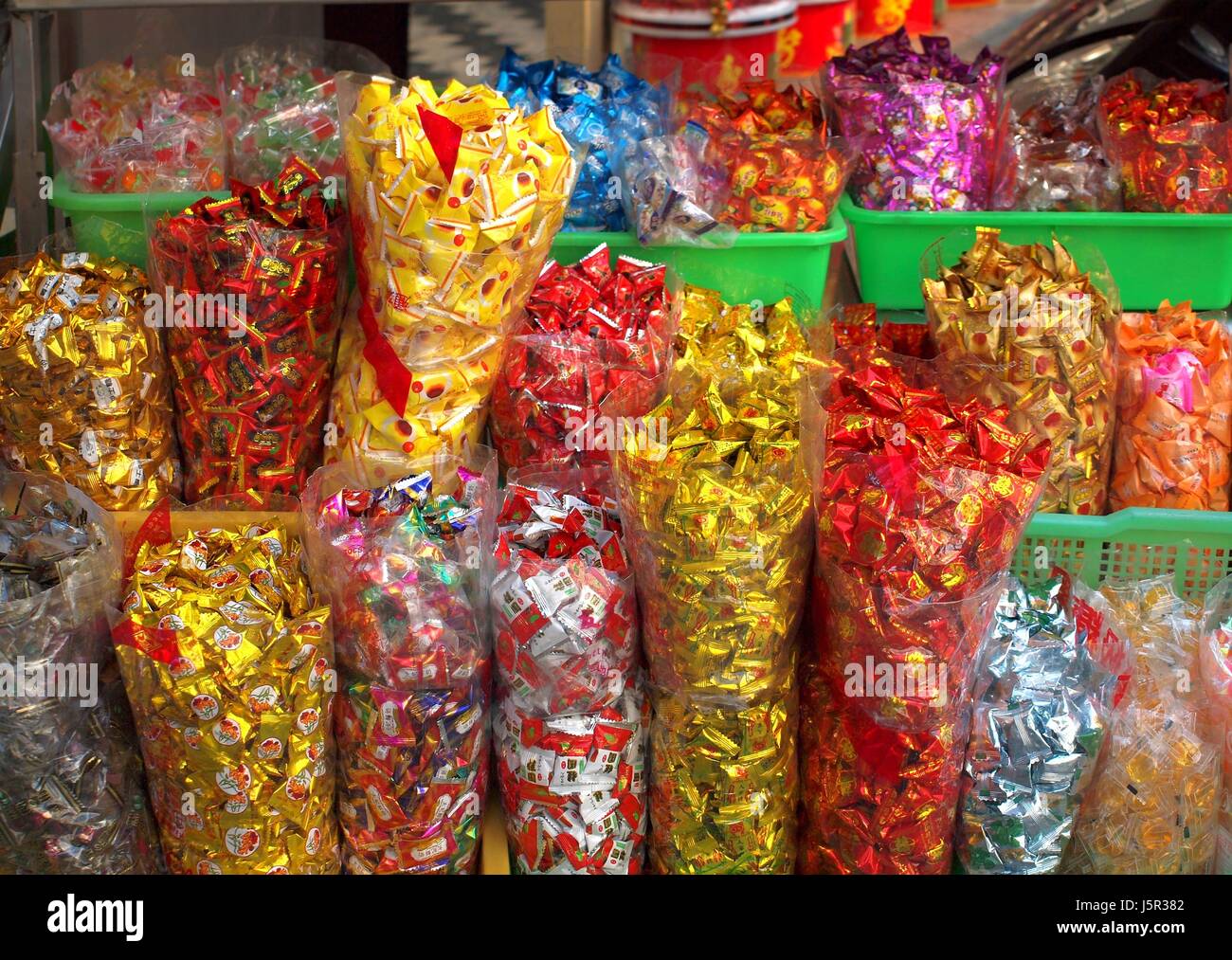 KAOHSIUNG, TAIWAN -- JANUARY 28, 2014: Large sacks of candy at an outdoor store. At Chinese New Year it is customary for people to have a variety of s Stock Photo