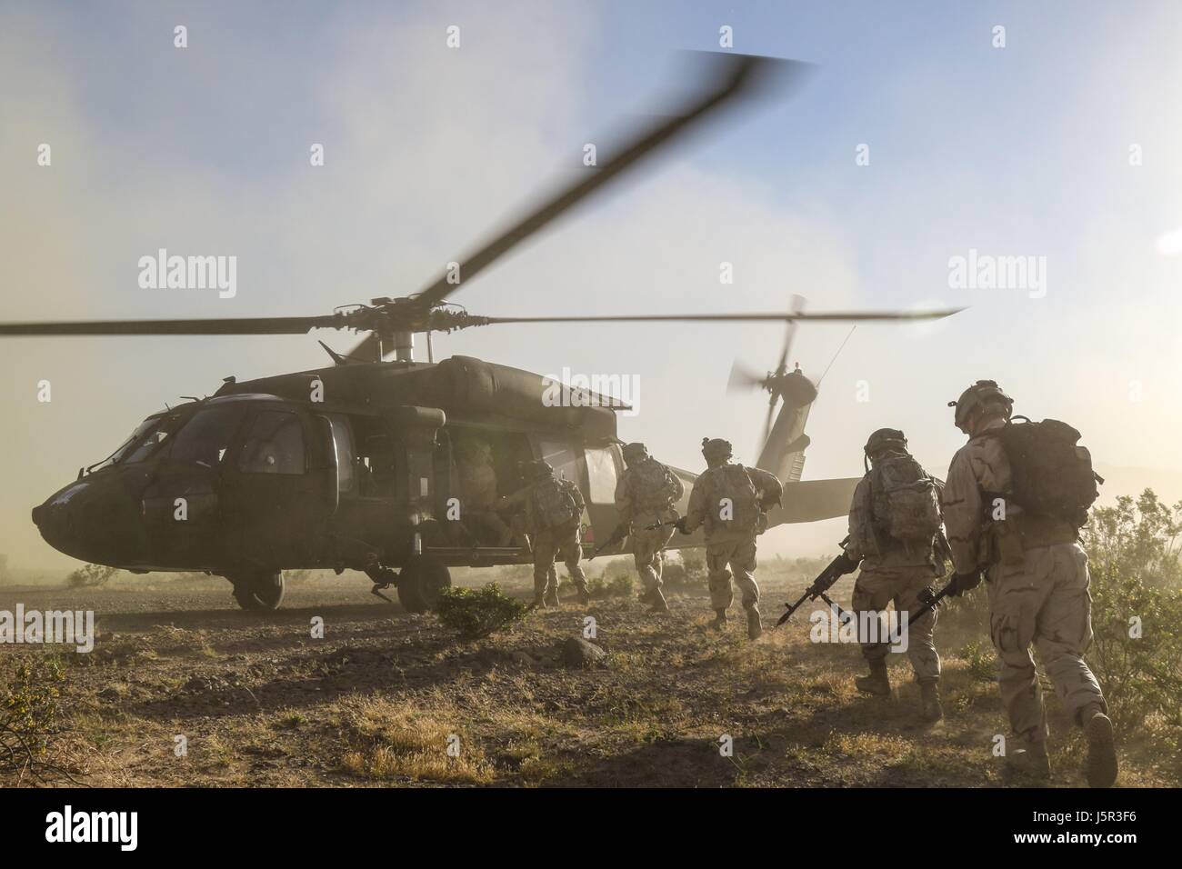 U.S. soldiers load into a U.S. Army UH-60 Black Hawk utility helicopter during a training exercise at the National Training Center May 4, 2017 in Fort Irwin, California.    (photo by Austin Anyzeski /US Army  via Planetpix) Stock Photo