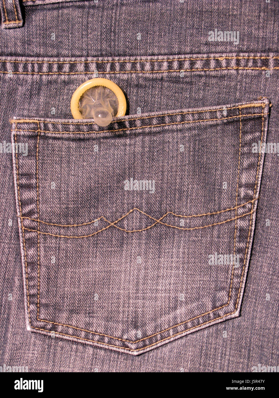 condom in jeans pocket Stock Photo - Alamy