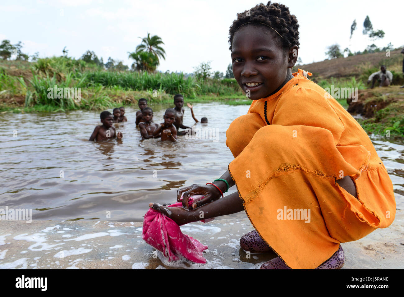 Malawi, Thyolo, village  Samuti, girl washing clothes at pond / Maedchen waescht Kleidung Stock Photo