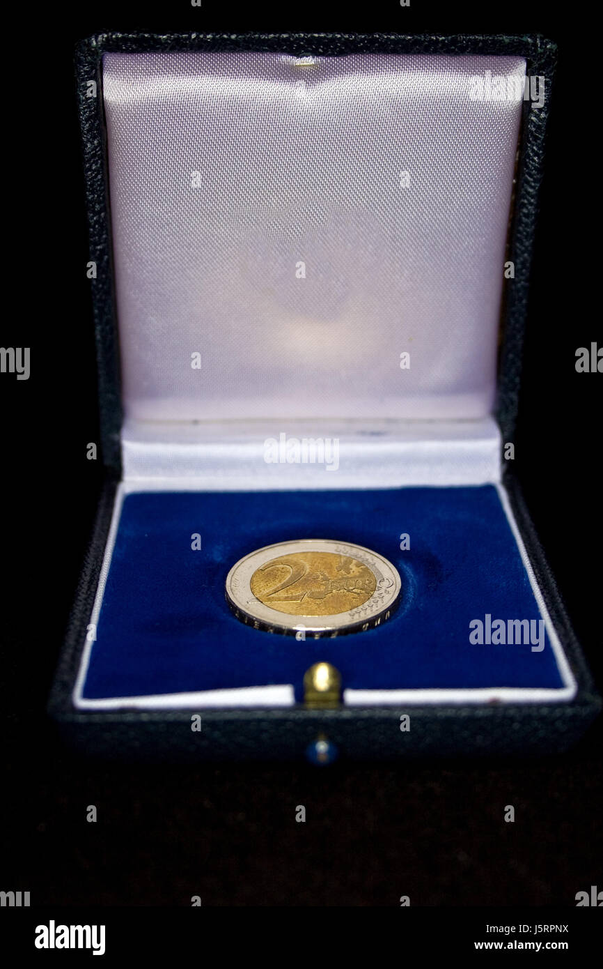 blue blank european caucasian euro coin metal seal shutter hold lid velvety Stock Photo