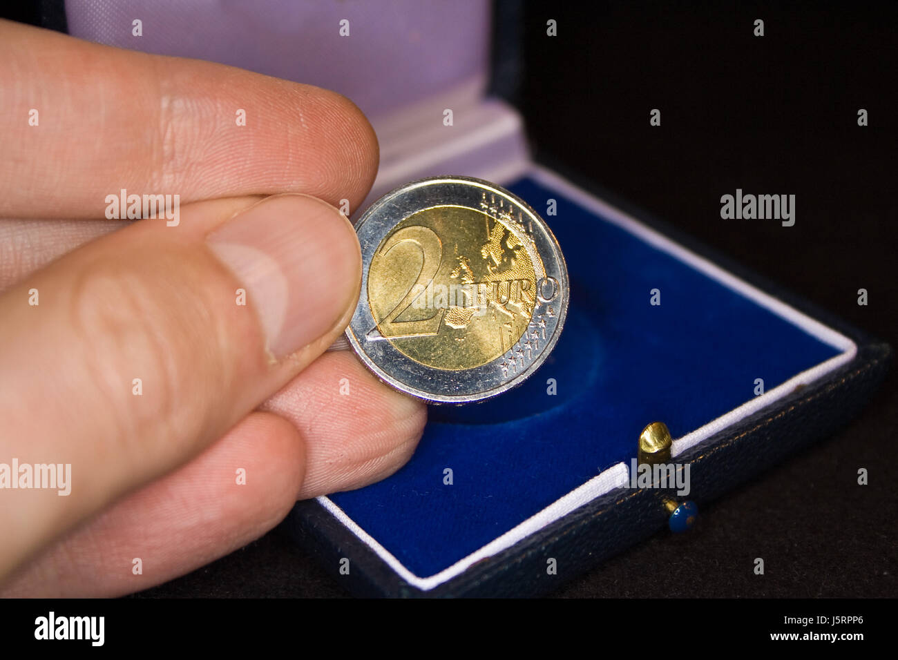 blue hand blank european caucasian euro coin metal seal shutter hold ...