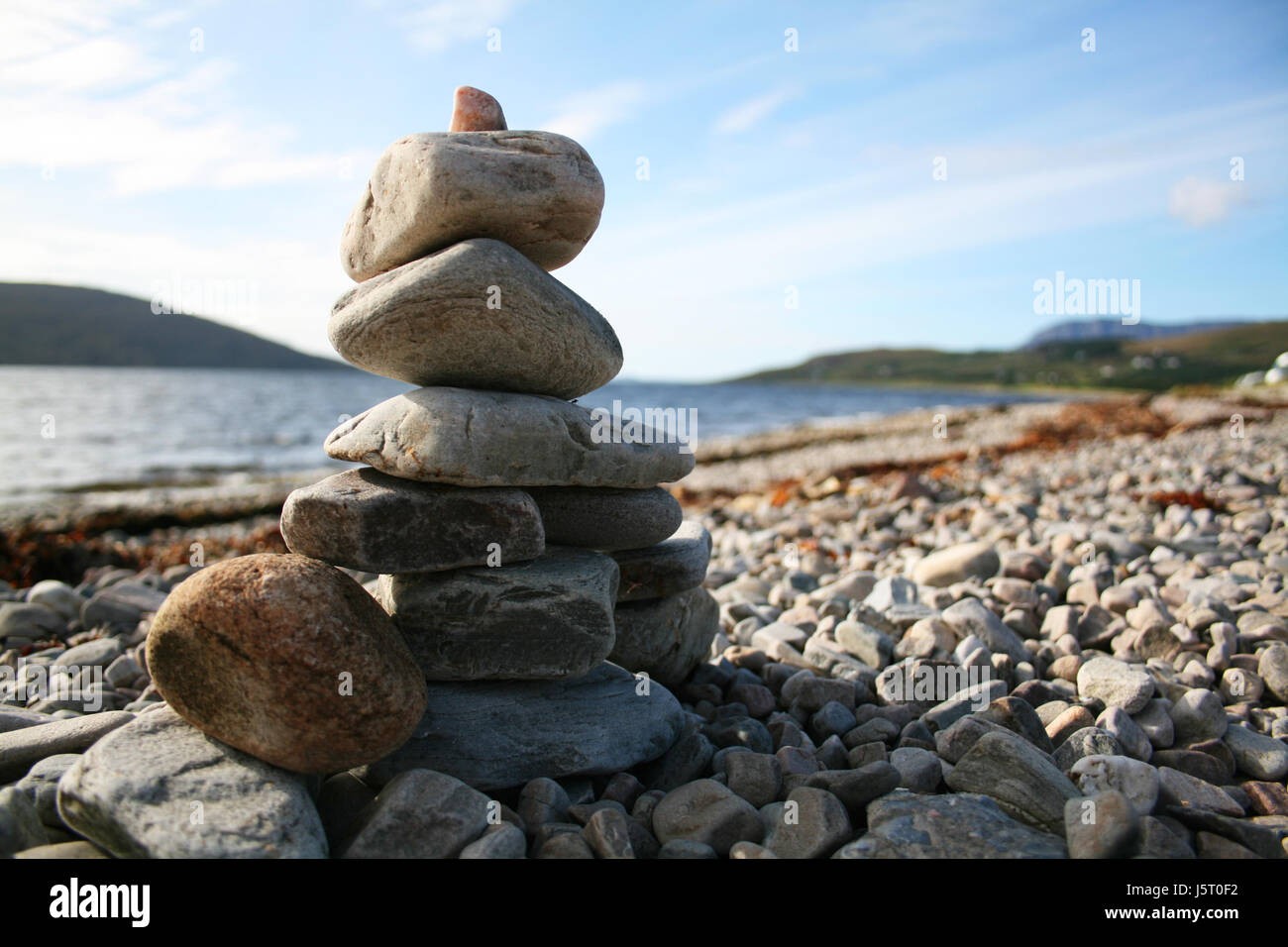 stone beach seaside the beach seashore pyramid stack salt water sea ocean water Stock Photo