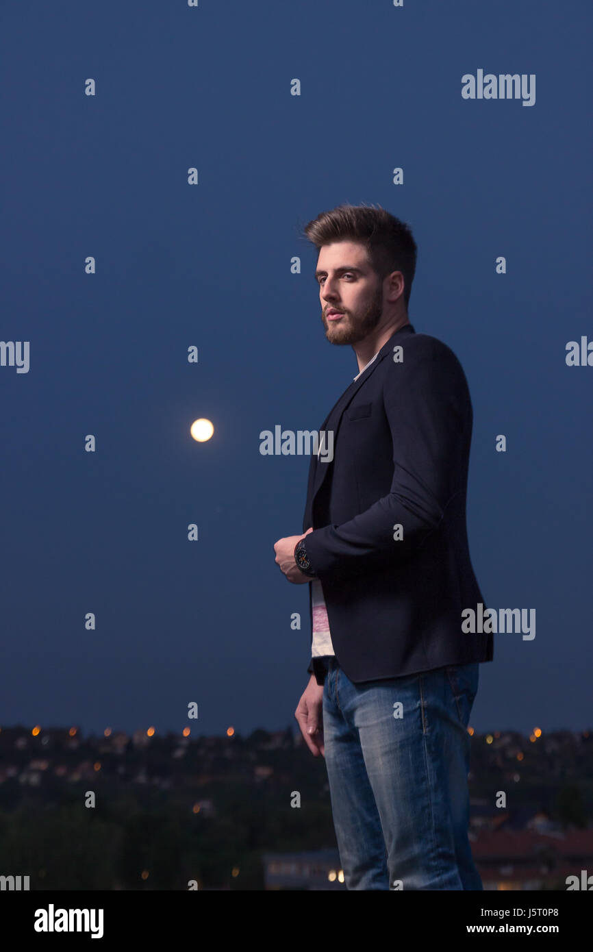portrait, one young adult man only, smart casual clothes, Moon sky night Stock Photo