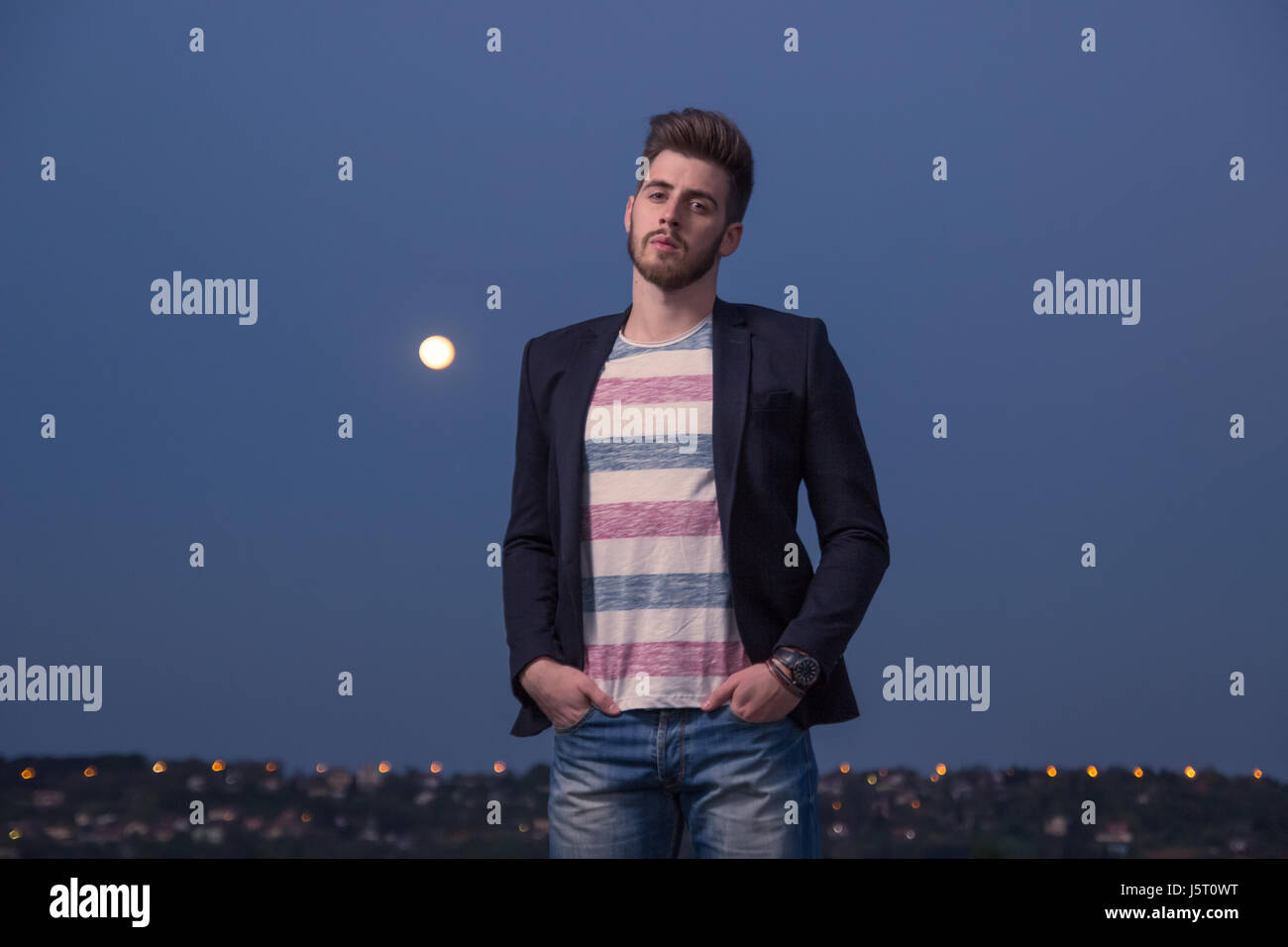 portrait, one young adult man only, smart casual clothes, Moon sky night Stock Photo