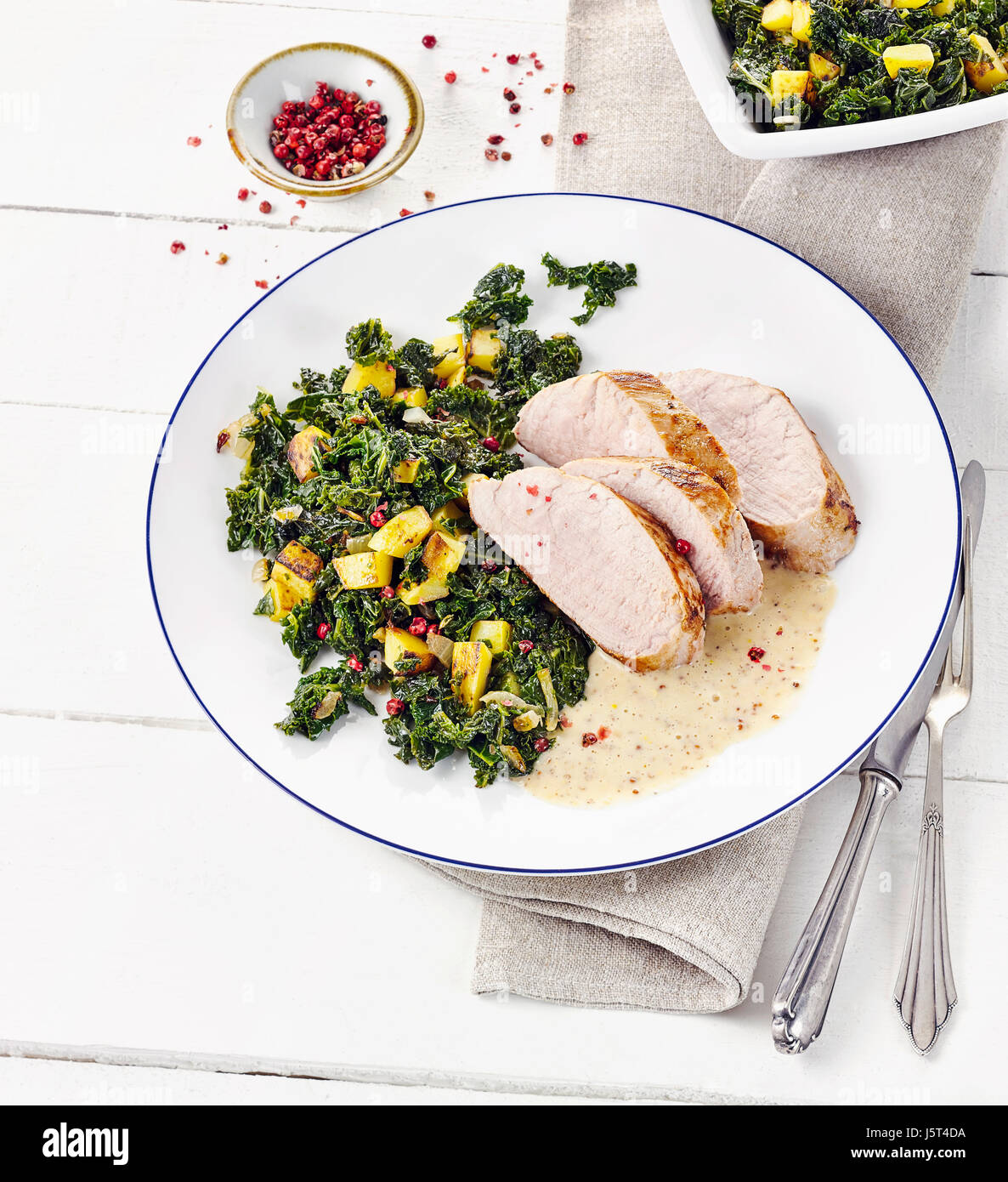 Pork filet with fried kale and mustard sauce Stock Photo Alamy