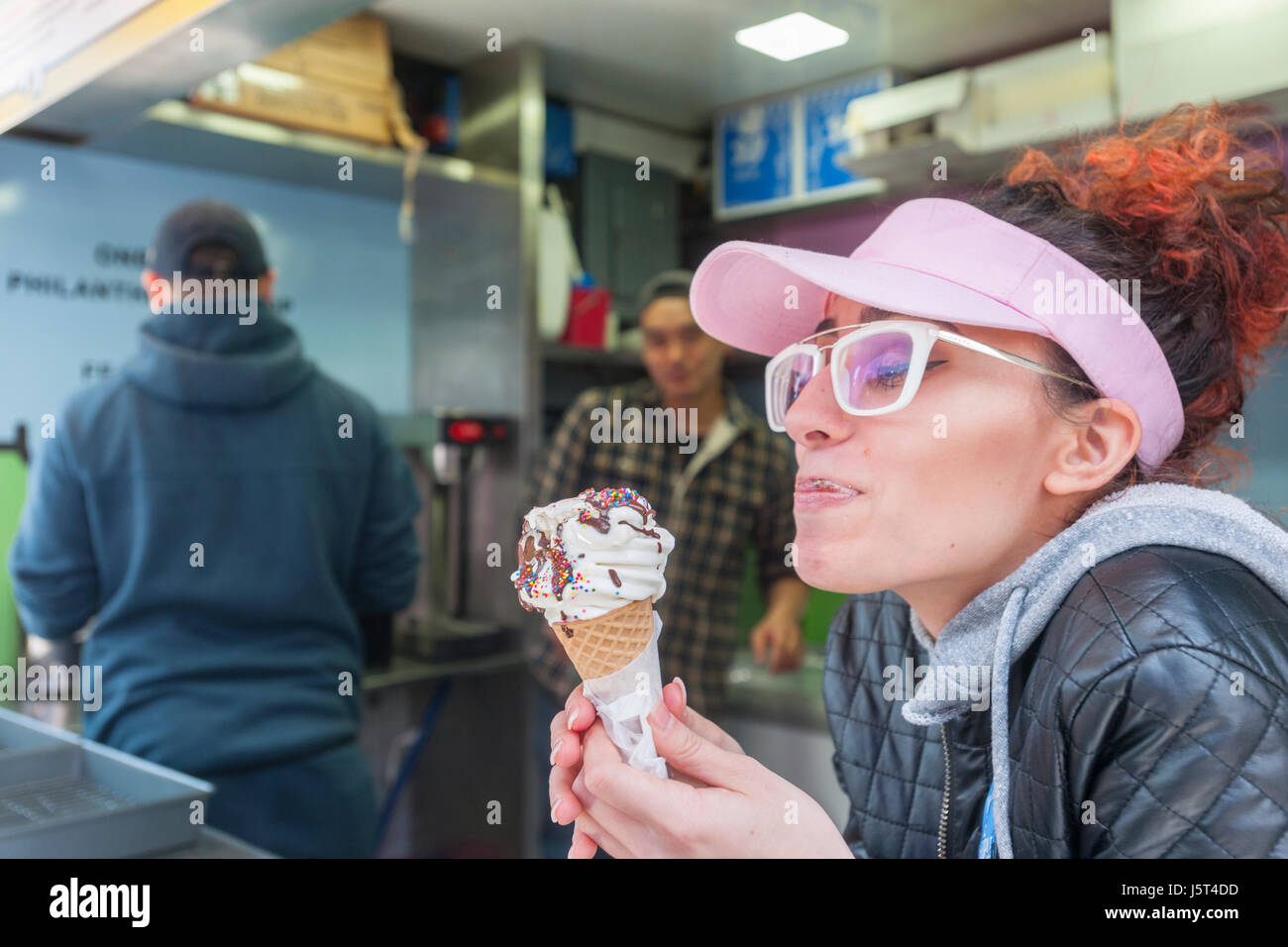 A worker samples an ice cream cone at the 'I Scream', Ice & Vice pop-up kiosk in Times Square in New York on Tuesday, May 16, 2017. 'I Scream's' menu features politically themed flavors such as Freeze Global Warming and No Mean No with five percent of each purchase going to organizations ACLU, Planned parenthood and the NRDC. The pop-up will be in Times Square through the summer. (© Richard B. Levine) Stock Photo