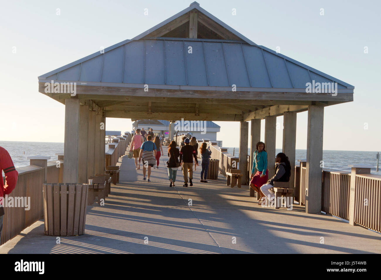 Clearwater Beach; Florida; USA - January 24, 2017:  Tourists gather to watch the sunset at Pier 60 on Clearwater Beach, a 1,080 foot fishing pier and  Stock Photo