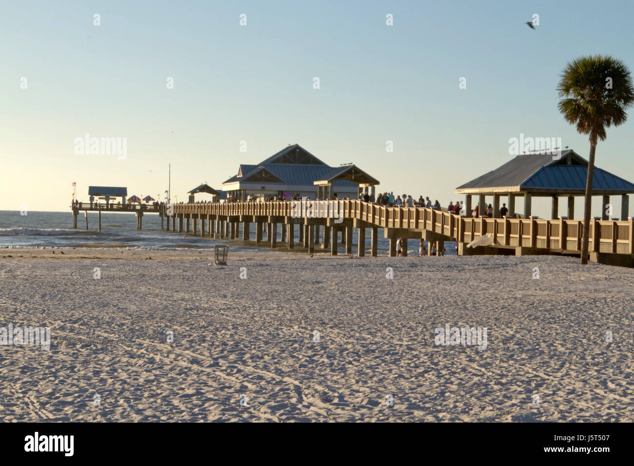 Clearwater Beach; Florida; USA - January 24, 2017:  Sunset at Pier 60 on Clearwater Beach, a 1,080 foot fishing pier and recreational park, with a bai Stock Photo