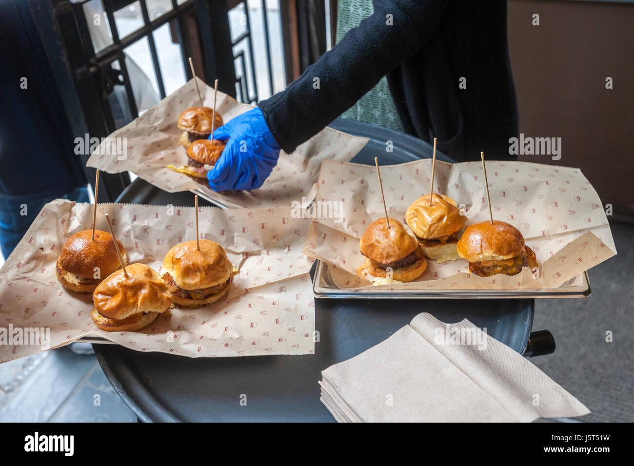 Bareburger Organic serves sliders after the unveiling of the new wayfinding kiosks that stand at either end of Restaurant Row in New York, West 46th street between 8th and 9th Avenues, on Tuesday May 16, 2017. At least four years in the making the illuminated kiosks show the names of the many eateries that populate the street. The unveiling is just in time for the Taste of Times Square event taking place on the street on June 5. (© Richard B. Levine) Stock Photo