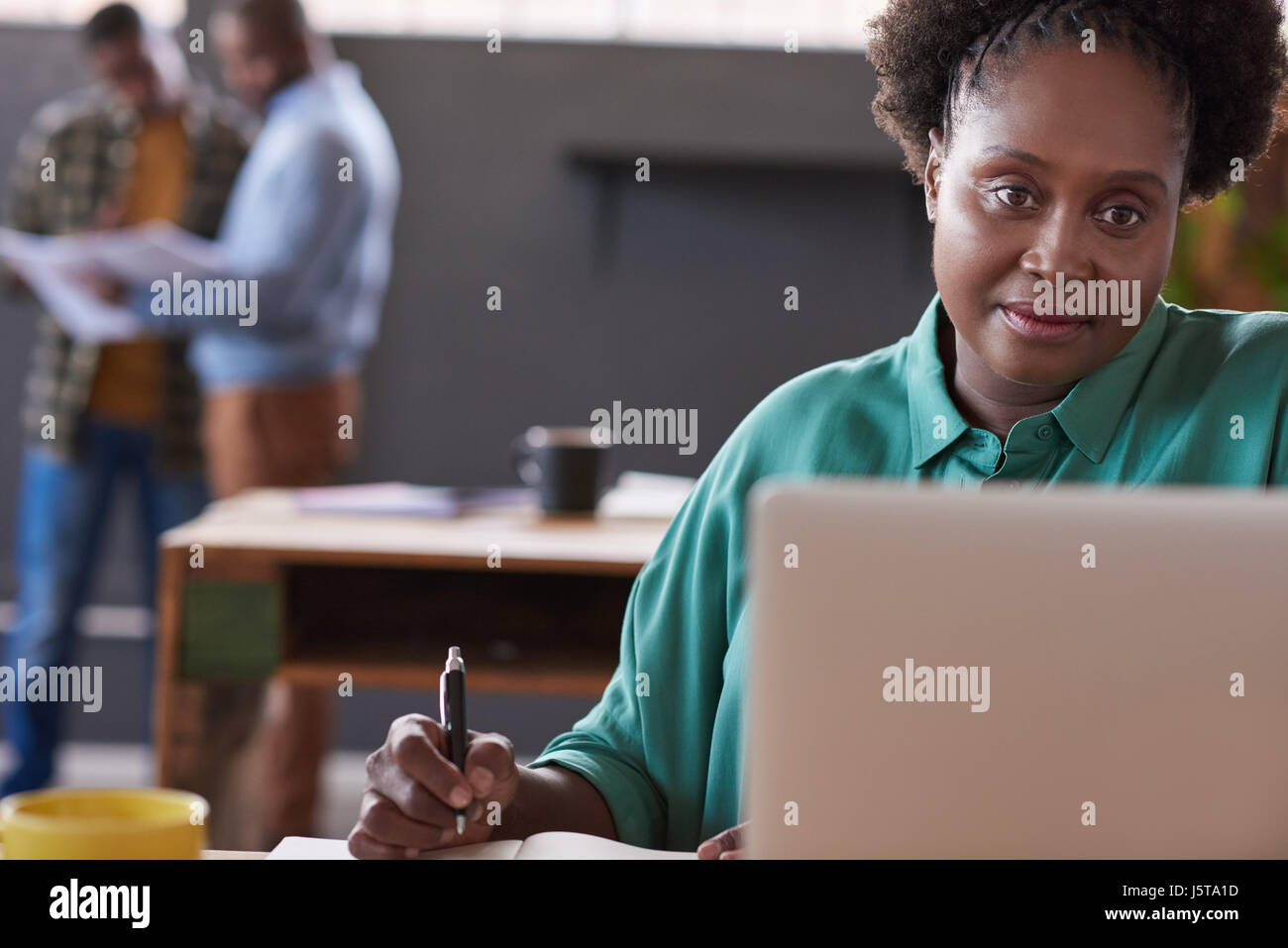 Businesswomen taking notes looking laptop hi-res stock photography and ...