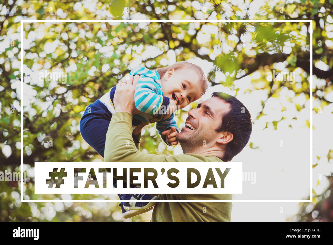 Father lifting baby son in the air. Fathers day. Stock Photo