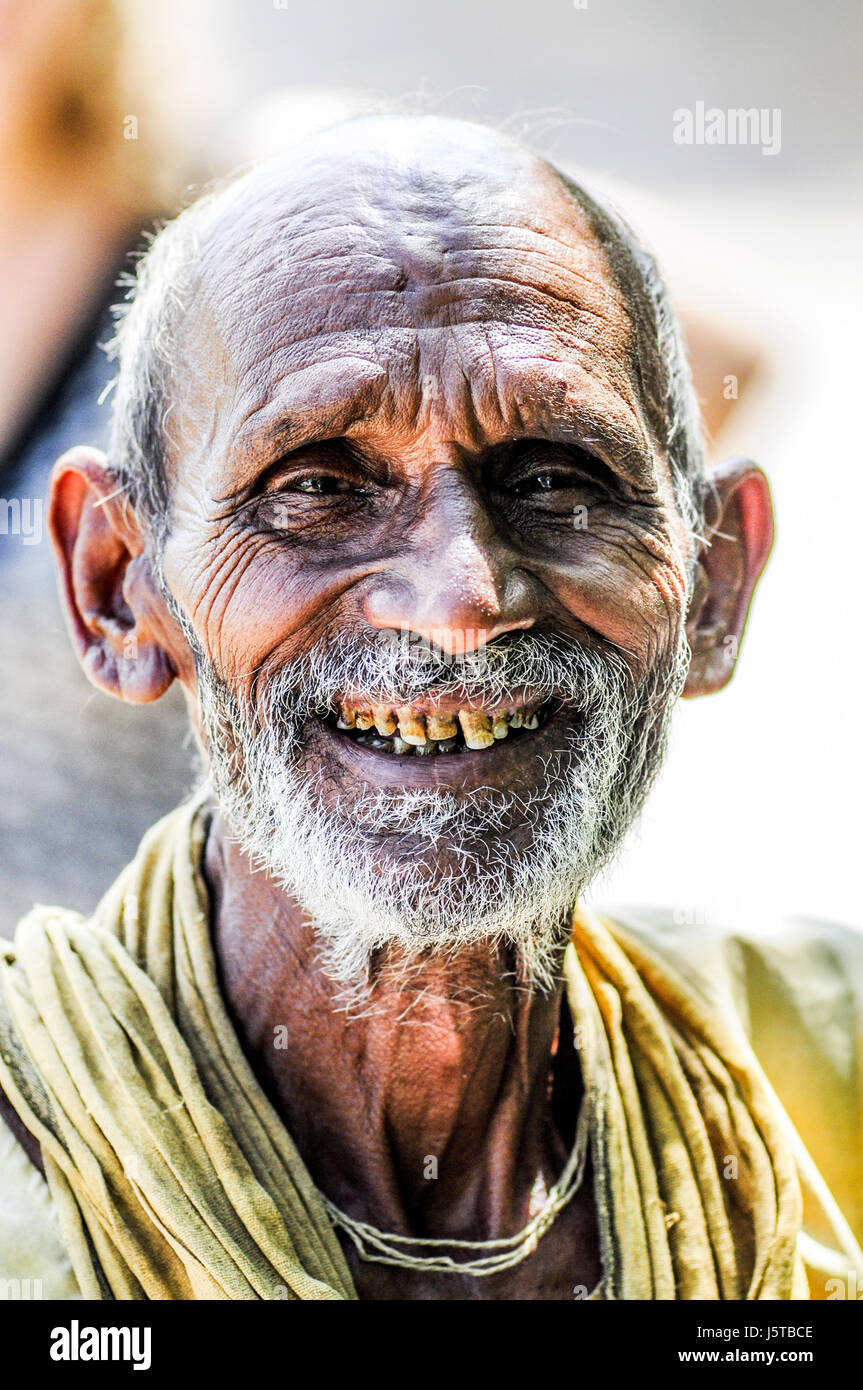 Khajuraho, India, september 17, 2010: Old indian man face smiling and looking on a photographer. Stock Photo