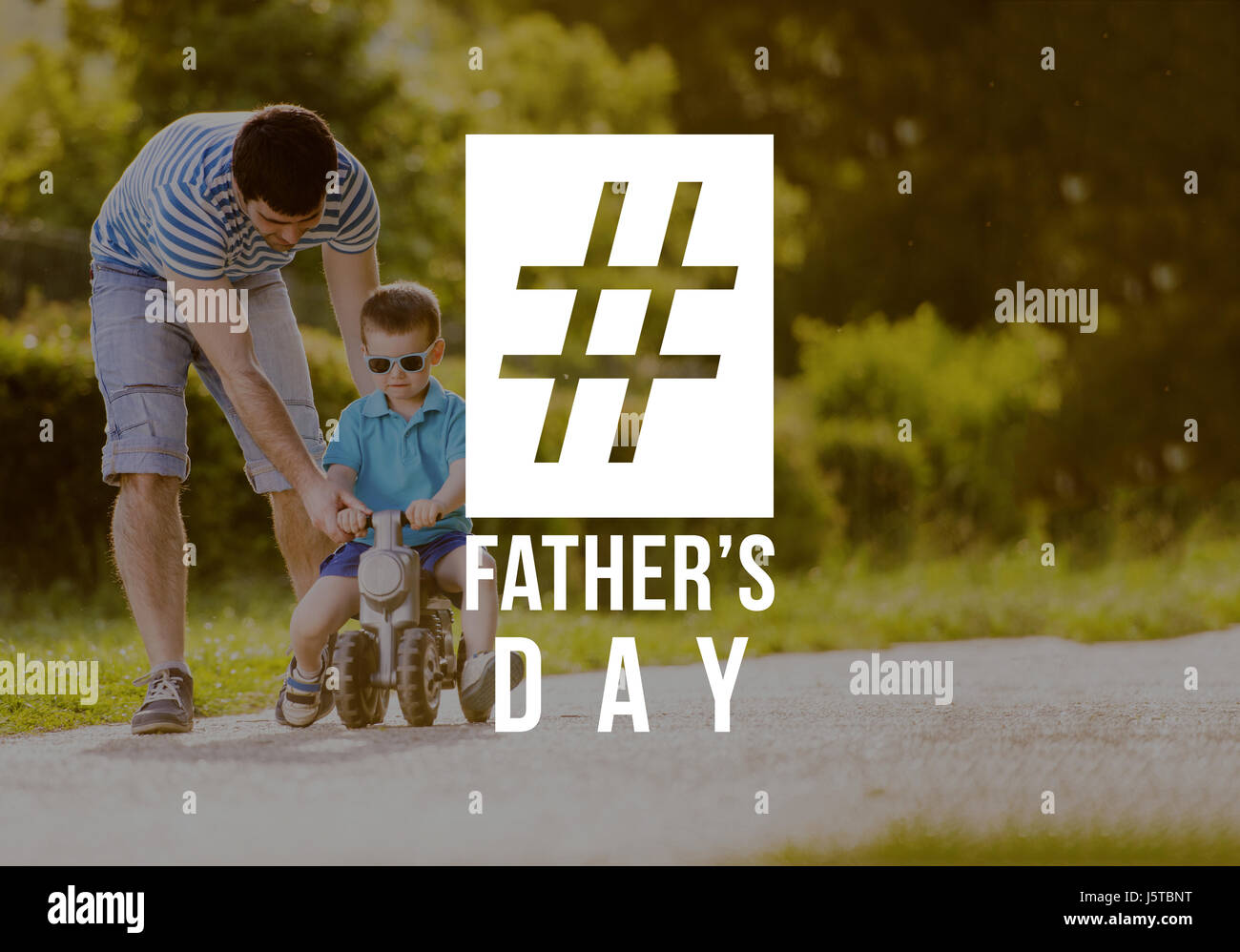 Father and son riding bike outdoors. Fathers day concept. Stock Photo