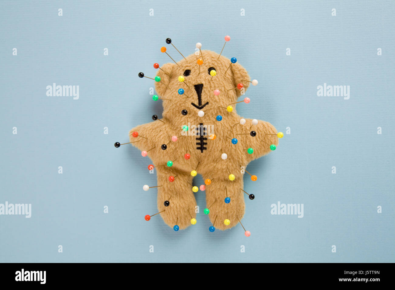 a quirky teddy bear like a voodoo doll isolated Stock Photo