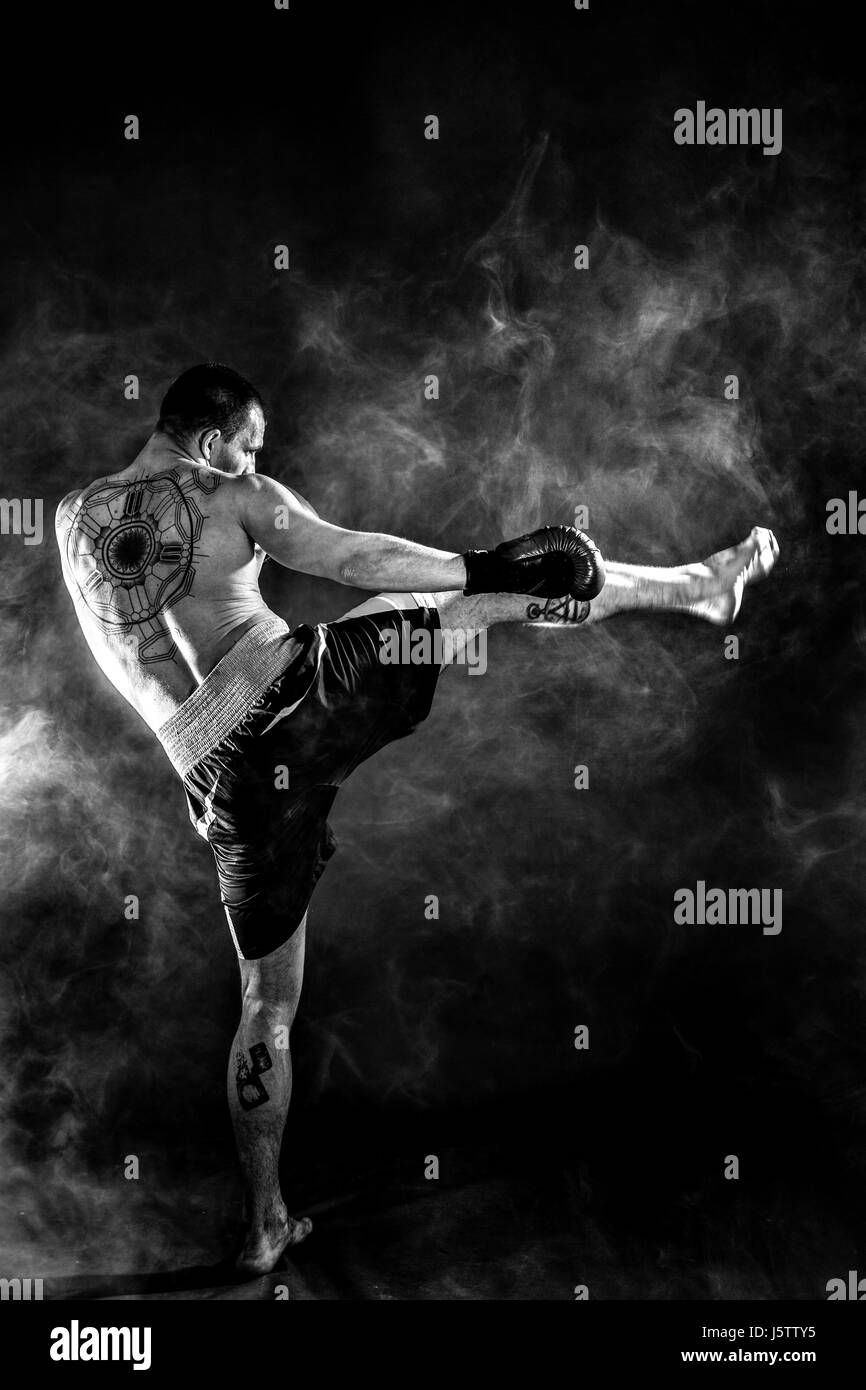 Happy Winning Mixed Martial Arts Fighter Punching in Smoke Stock Photo